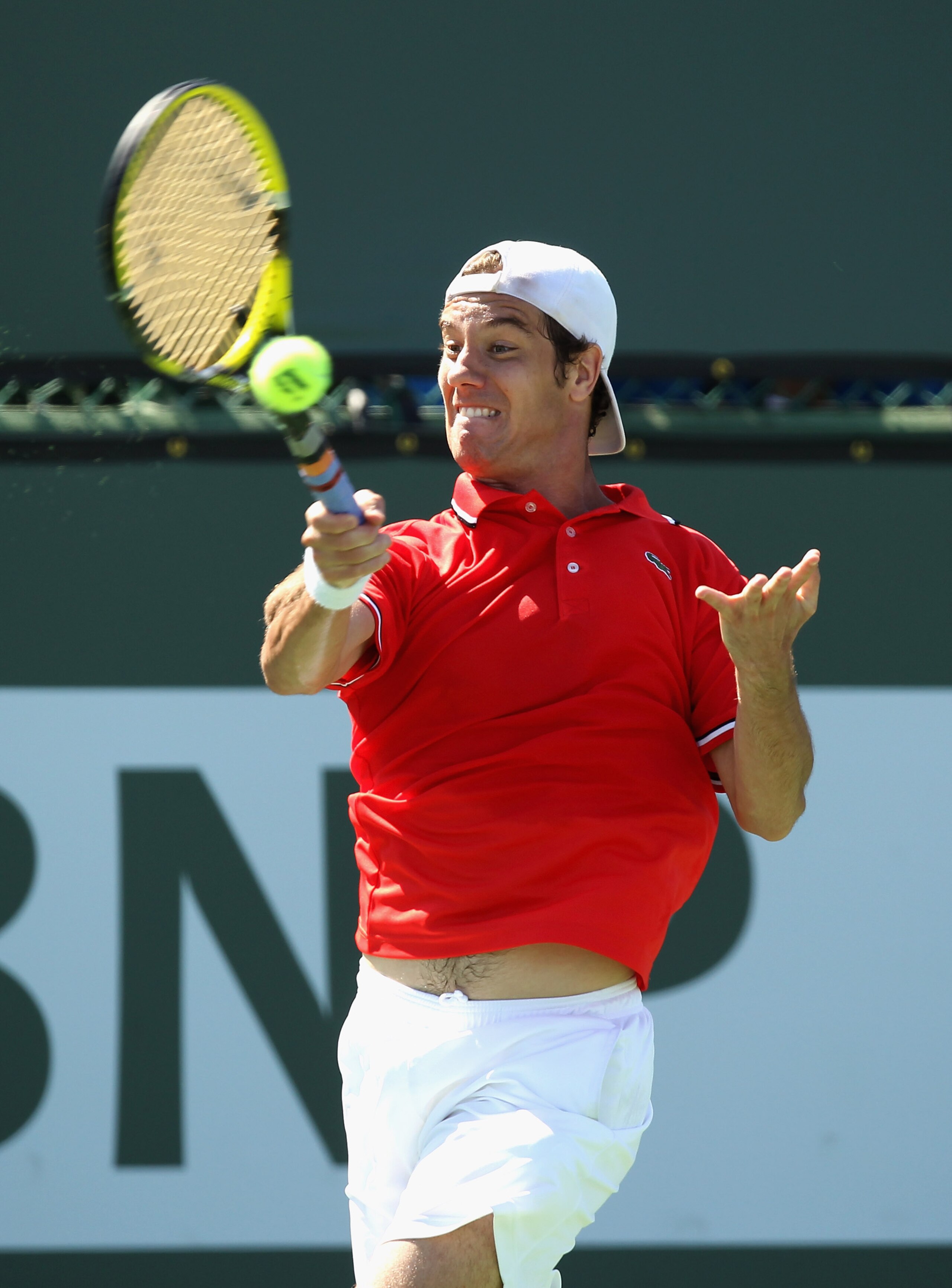 INDIAN WELLS, CA - MARCH 13:  Richard Gasquet of France returns a shot to Pablo Cuevas of Uruguay during the BNP Paribas Open at the Indian Wells Tennis Garden on March 13, 2011 in Indian Wells, California.  (Photo by Ezra Shaw/Getty Images)