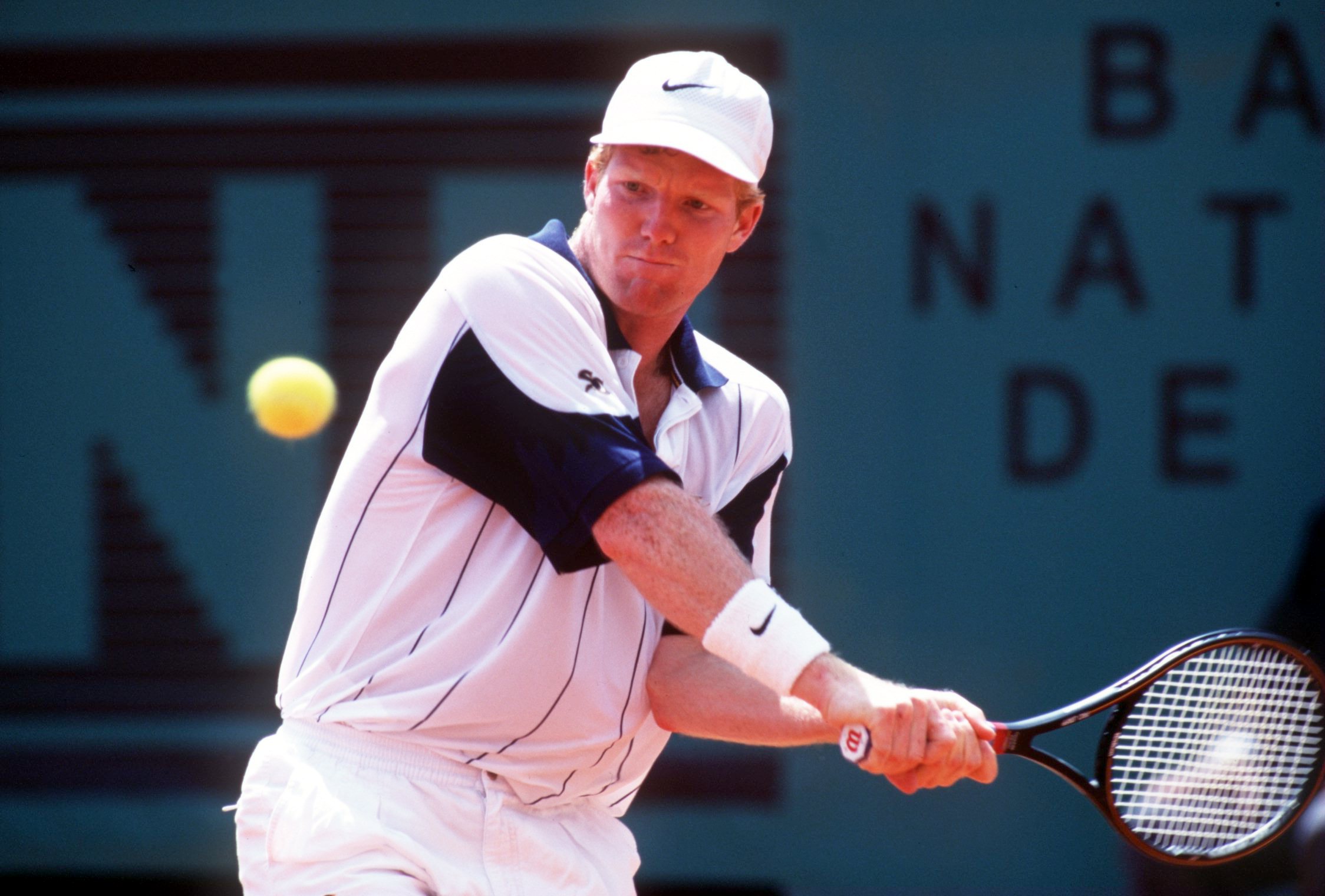 3 JUN 1994:  JIM COURIER OF THE USA  KEEPS HIS EYES ON THE BALL AS HE HITS A DOUBLEHANDED RETURN DURING HIS DEFEAT TO SERGI BRUGUERA OF SPAIN IN THREE STRAIGHT SETS IN THE FIRST OF THE MENS SEMIFINALS AT THE FRENCH OPEN TENNIS AT ROLAND GARROS IN PARIS.Ma