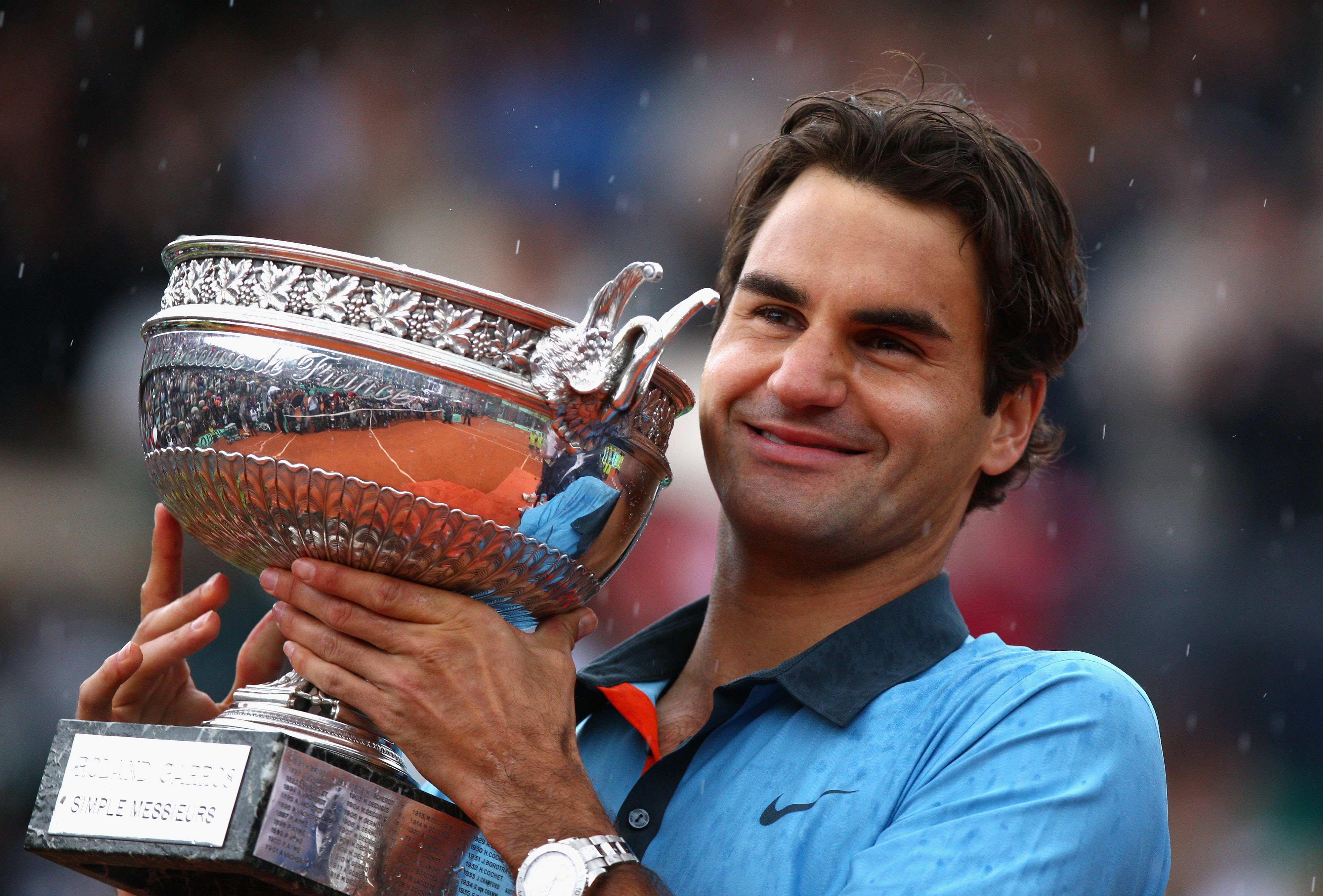 PARIS - JUNE 07:  Roger Federer of Switzerland poses with the trophy as he celebrates victory during the Men's Singles Final match against Robin Soderling of Sweden on day fifteen of the French Open at Roland Garros on June 7, 2009 in Paris, France.  (Pho