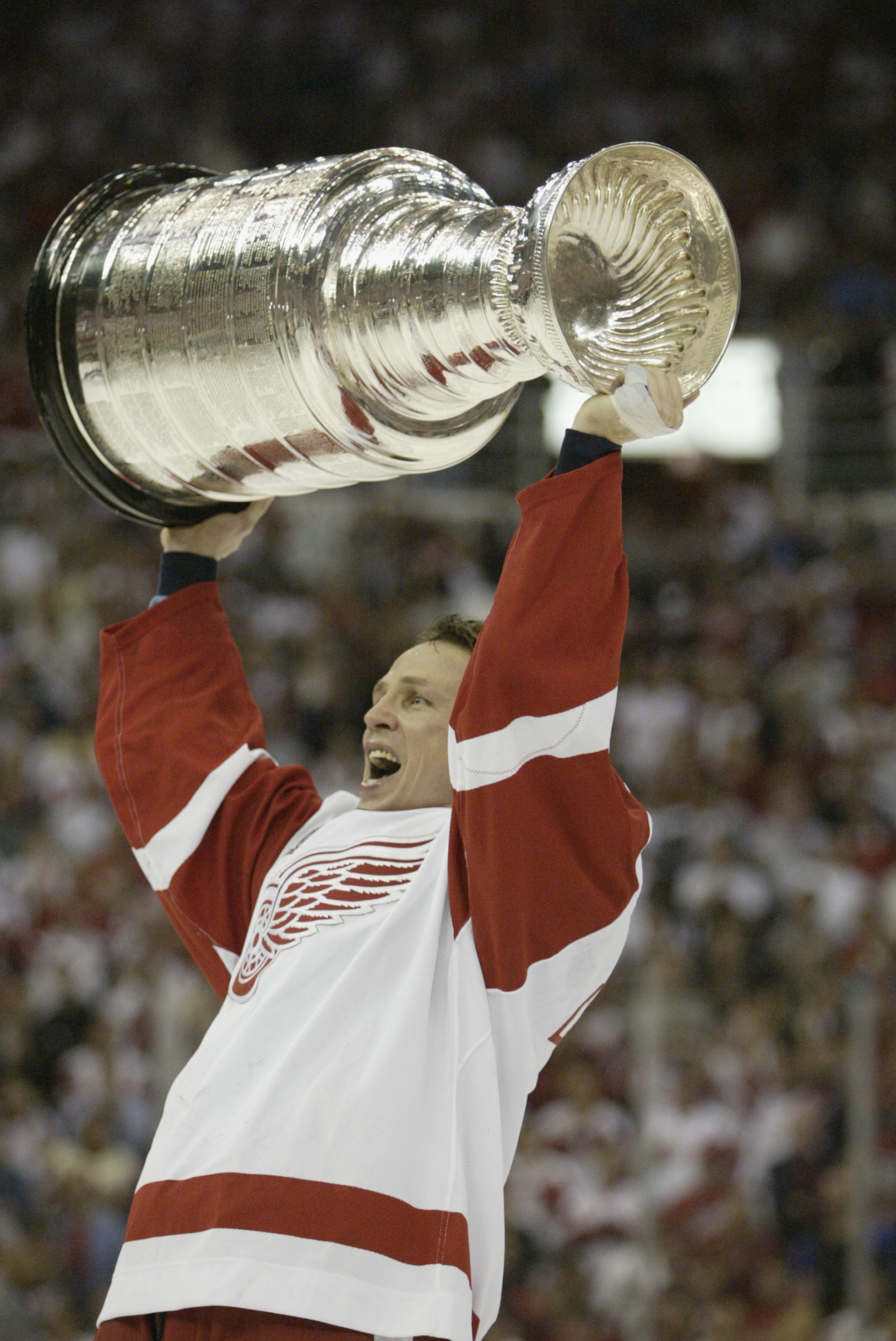 DETROIT, MI - JUNE 13:  Igor Larionov of the Detroit Red Wings raises the Stanley Cup after eliminating the Carolina Hurricanes during game five of the NHL Stanley Cup Finals on June 13, 2002 at the Joe Louis Arena in Detroit, Michigan.  The Red Wings won
