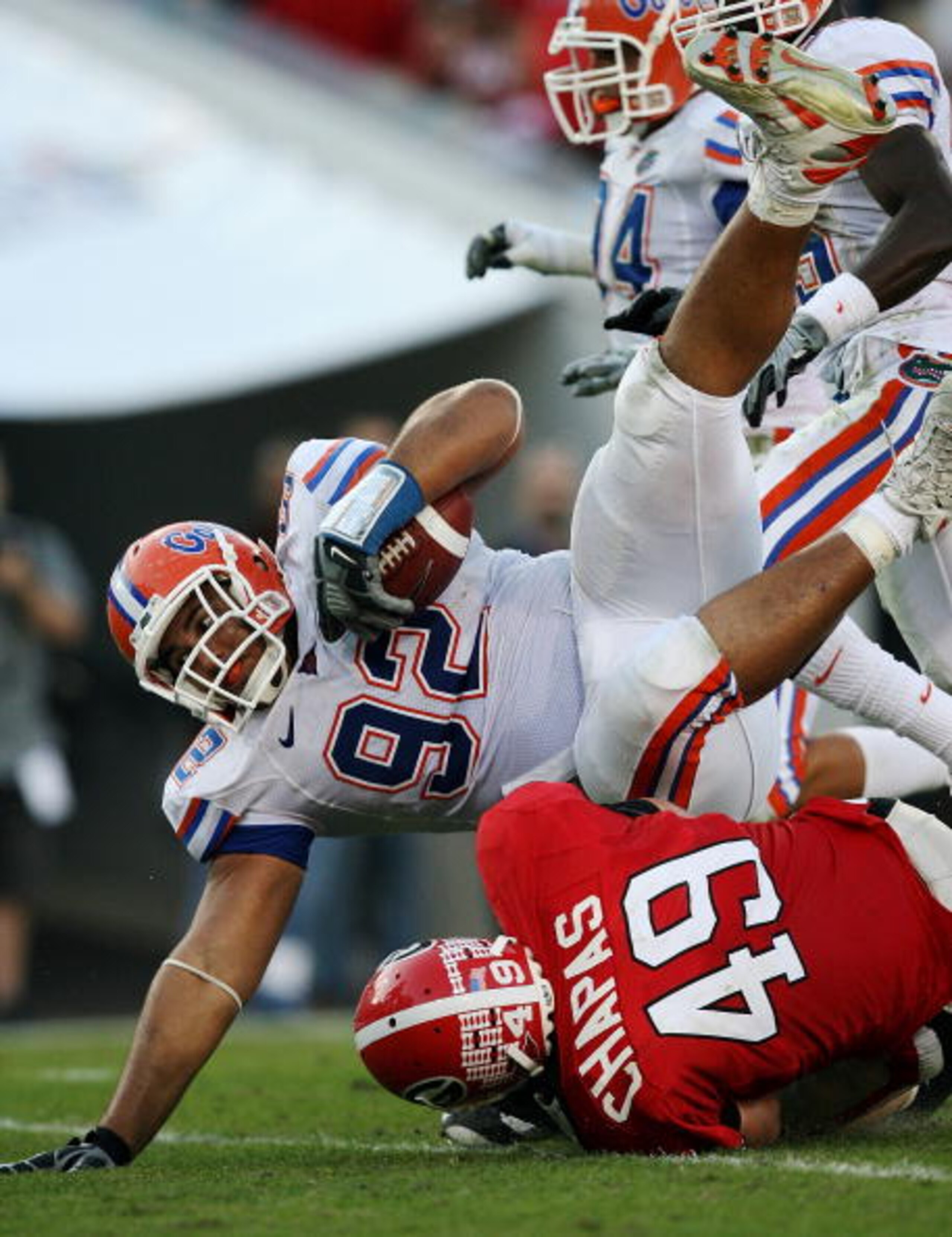 JACKSONVILLE, FL - NOVEMBER 01:  Defensive tackle Terron Sanders #92 of the Florida Gators is upended by fullback Shaun Chapas #49 of the Georgia Bulldogs after Sanders returned a fumble in the third quarter at Jacksonville Municipal Stadium on November 1