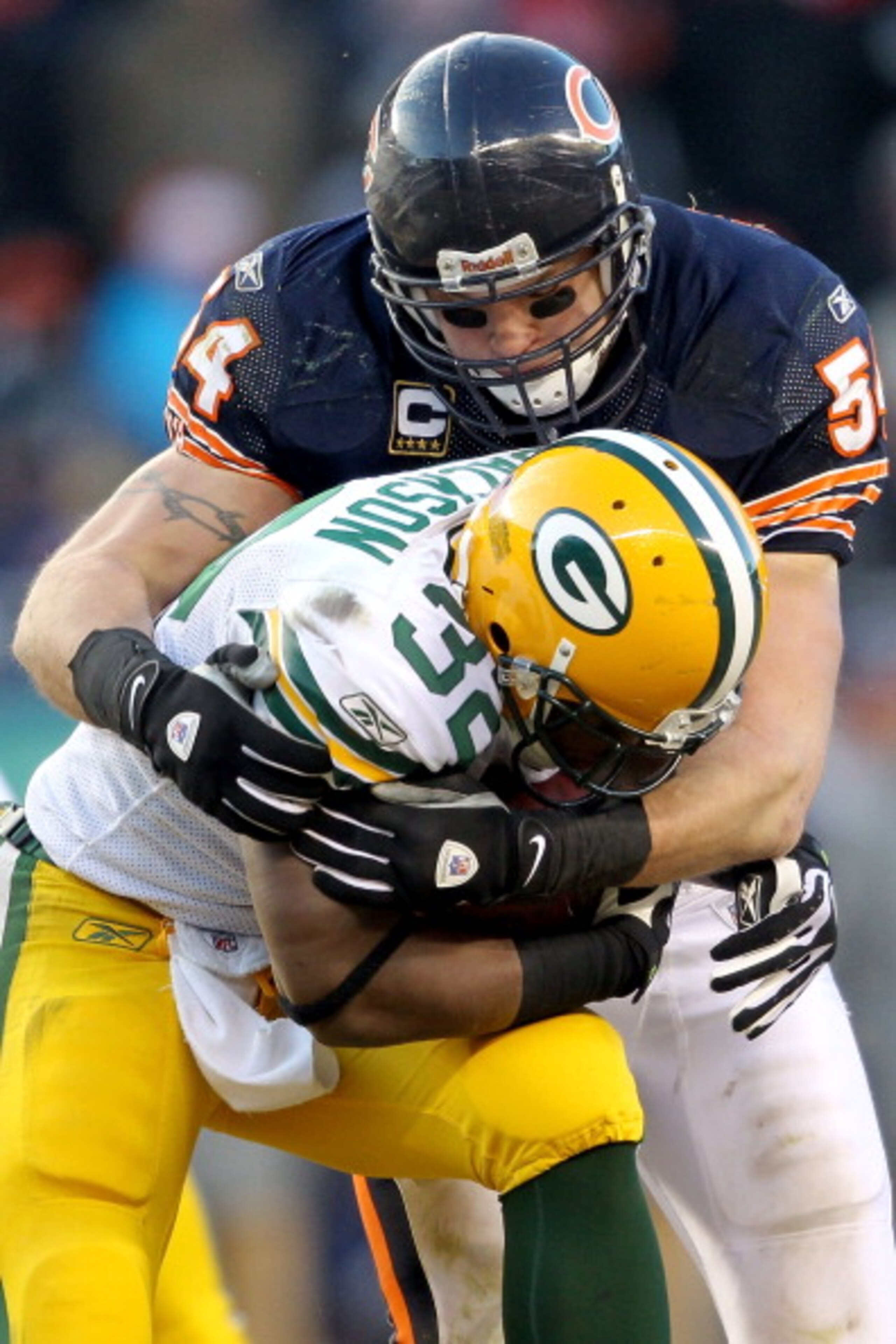 CHICAGO, IL - JANUARY 23:  Running back Brandon Jackson #32 of the Green Bay Packers is tackled by Brian Urlacher #54 of the Chicago Bears in the second half in the NFC Championship Game at Soldier Field on January 23, 2011 in Chicago, Illinois.  (Photo b