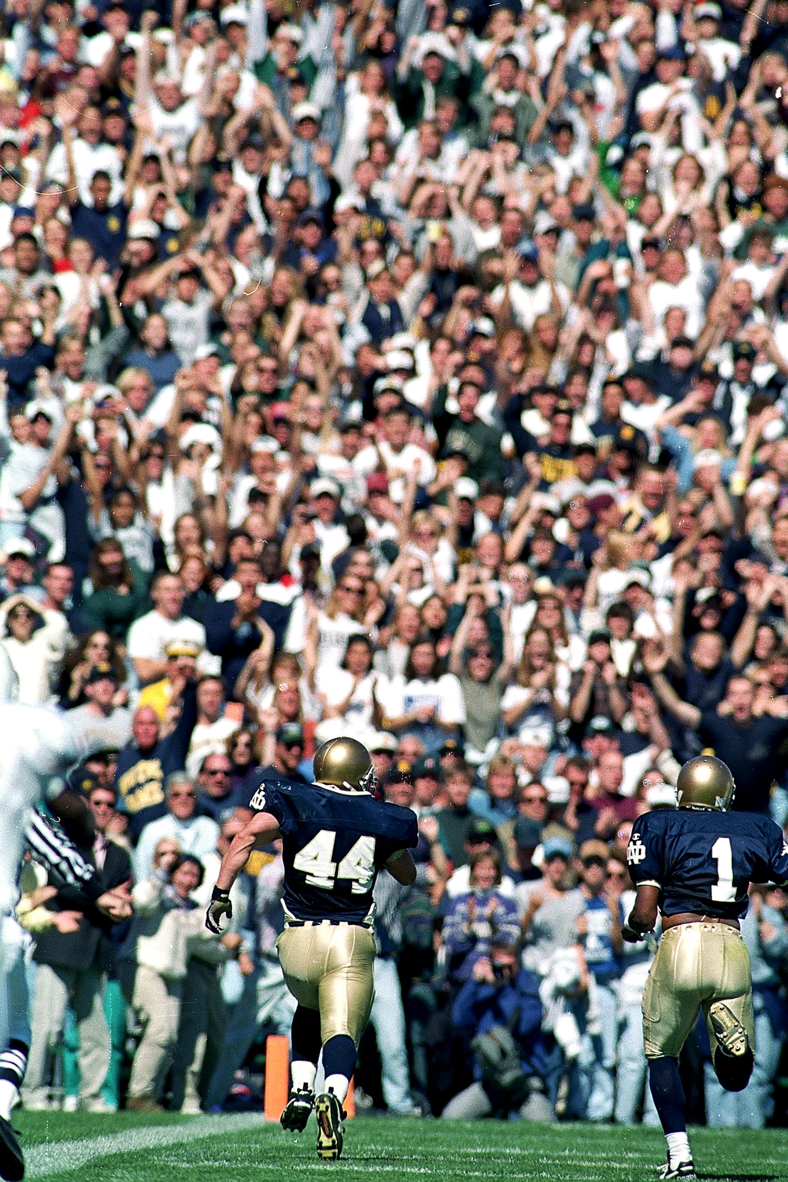 23 Sep 1995:  Derrick Mayers #1 of the Notre Dame Fighting Irish runs to make a touch down as teammate Mark Edwards #44 runs beside him during the game against the Texas Longhorns at the Notre Dame Stadium at Notre Dame, Indiana. The Fighting Irish defeat