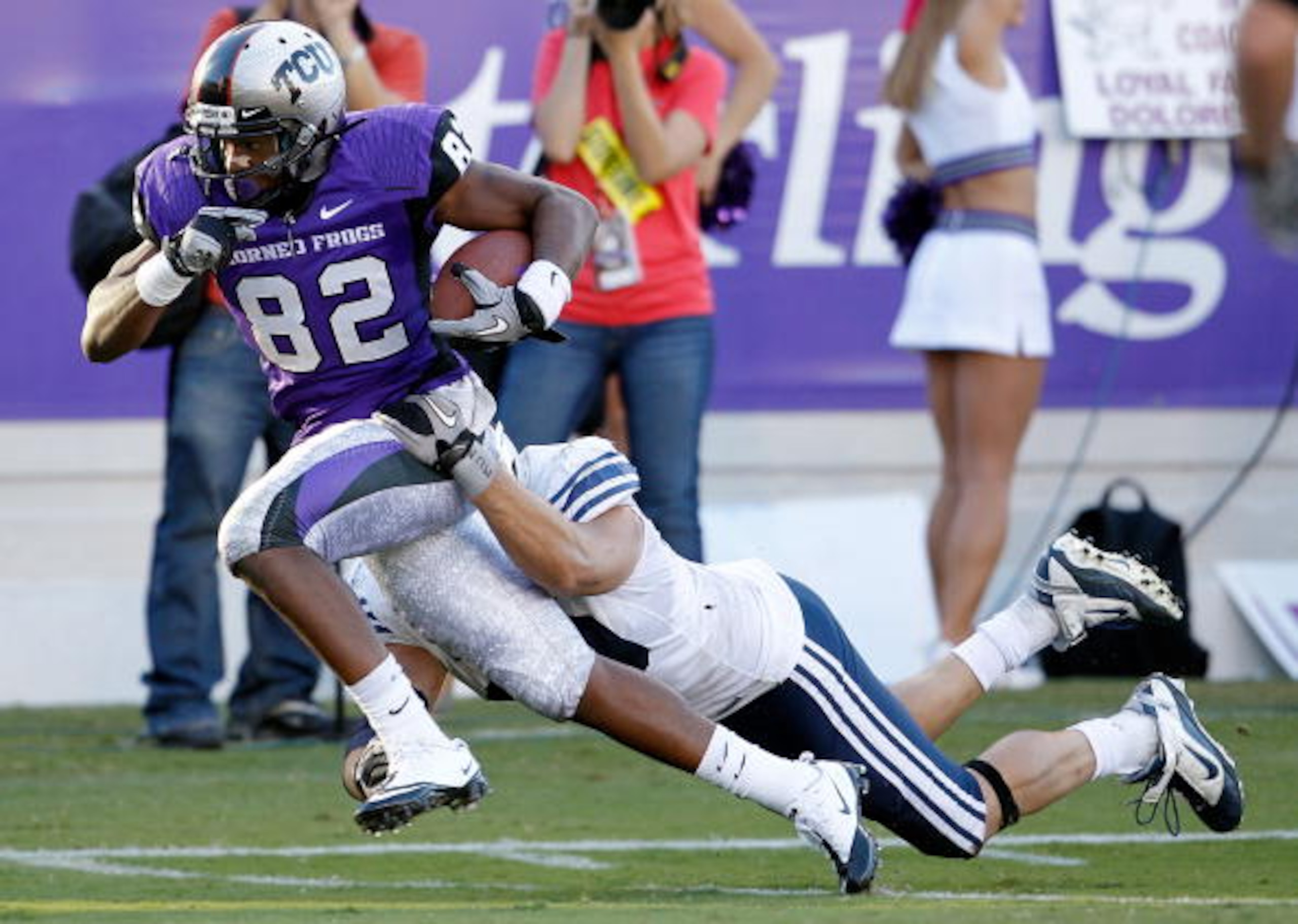 FORT WORTH, TX - OCTOBER 16:  Wide receiver Josh Boyce #82 of the TCU Horned Frogs scores a touchdown against line backer Jadon Wagner #49 the BYU Cougars at Amon G. Carter Stadium on October 16, 2010 in Fort Worth, Texas.  TCU beat BYU 31-3.  (Photo by T