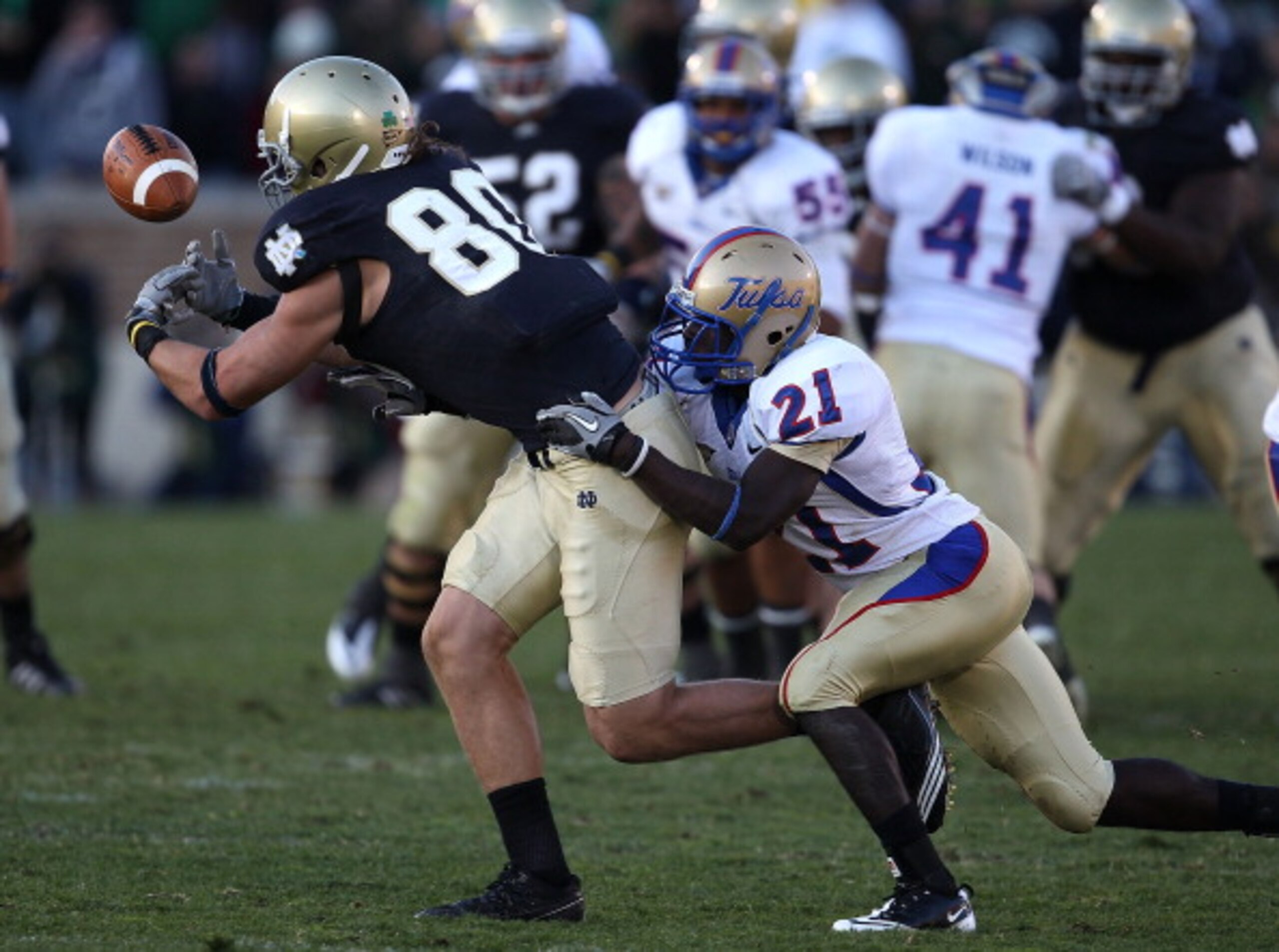 SOUTH BEND, IN - OCTOBER 30: Tyler Eifert #80 of the Notre Dame Fighting Irish drops a pass as he is hit by John Flanders #21 of the Tulsa Golden Hurricane at Notre Dame Stadium on October 30, 2010 in South Bend, Indiana. Tulsa defeated Notre Dame 28-27.