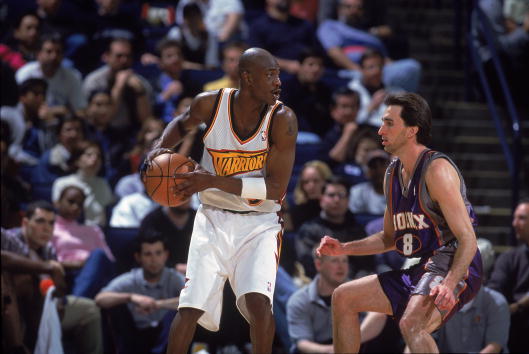13 Feb 2001:  Vonteego Cummings #5 of the Golden State Warriors moves with the ball against Vinny Del Negro #8 of the Phoenix Suns during the game at The Arena in Oakland, California. The Suns defeated the Warriors 93-83.  NOTE TO USER: It is expressly un