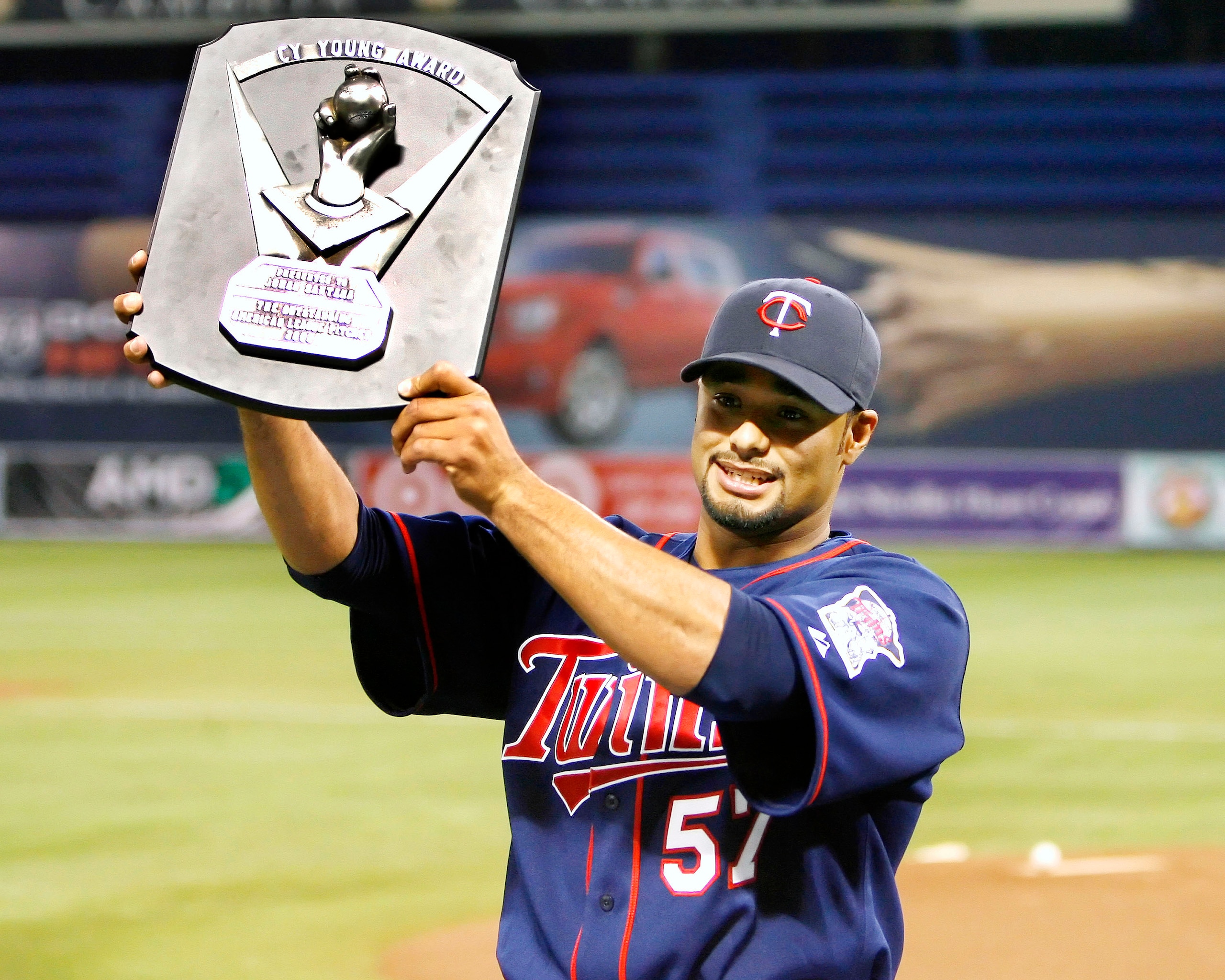 MINNEAPOLIS, MN - APRIL 14:  Johan Santana #57 of the Twins holds up the 2006 Cy Young Award on April 14, 2007 at the Metrodome in Minneapolis, Minnesota.  (Photo by Scott A. Schneider/Getty Images)