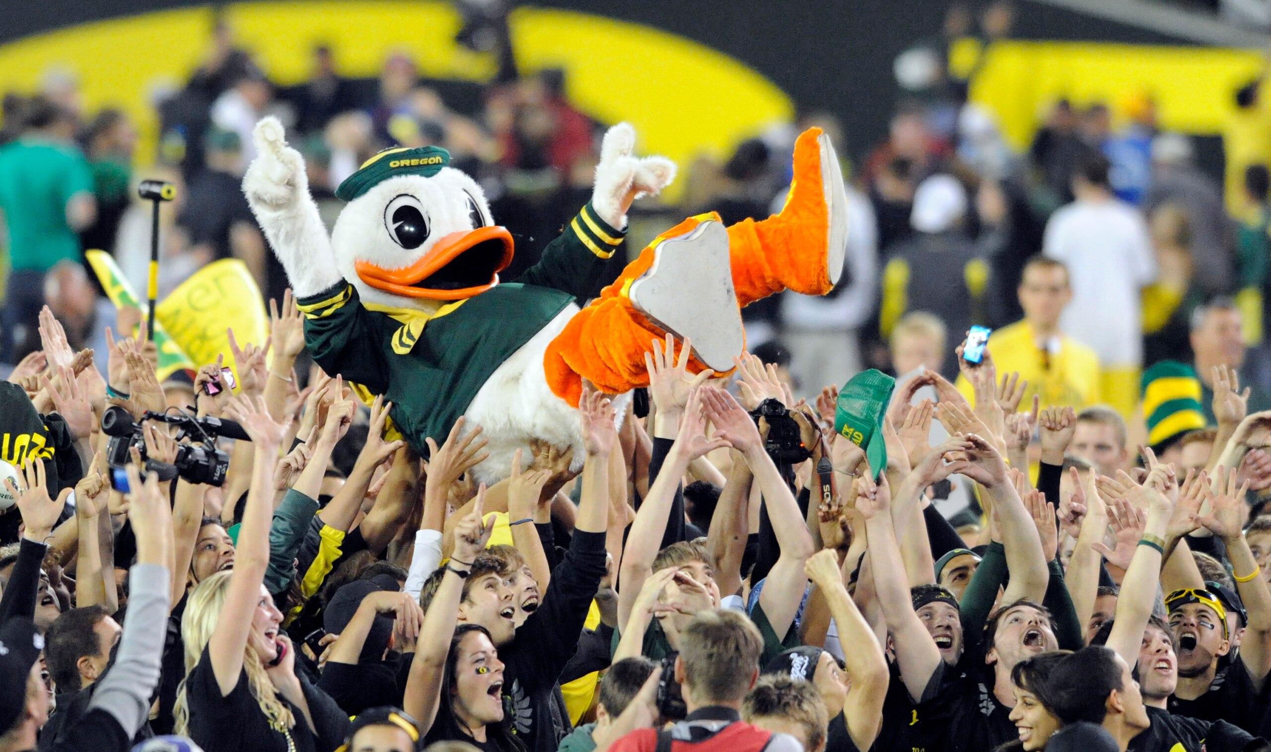 EUGENE, OR - OCTOBER 2: Puddles the Oregon Duck mascot is carried on the shoulders of fans on the feild of Autzen Stadium after the Oregon Ducks beat the Stanford Cardinal 52-31 at Autzen Stadium on October 2, 2010 in Eugene, Oregon. (Photo by Steve Dykes