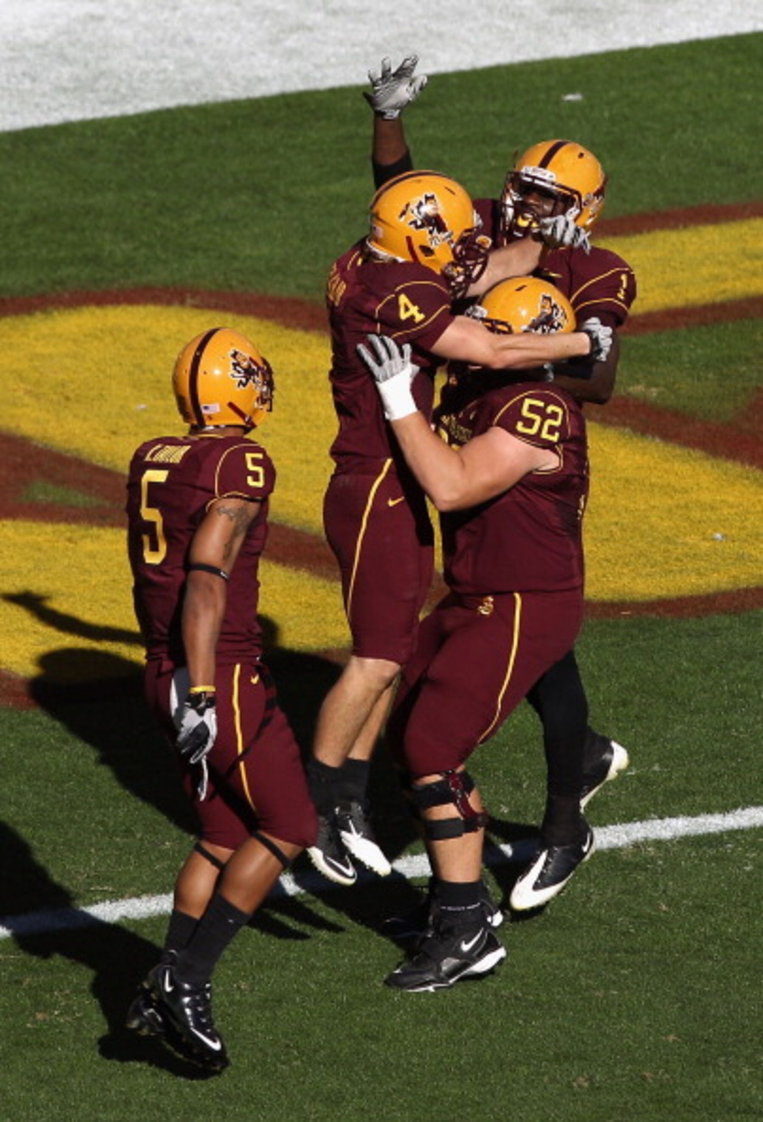 TEMPE, AZ - NOVEMBER 26:  Wide receiver Aaron Pflugrad #4 of the Arizona State Sun Devils celebrates a touchdown reception against the UCLA Bruins with teammate Mike Willie #1 and Garth Gerhart #52 during the college football game at Sun Devil Stadium on