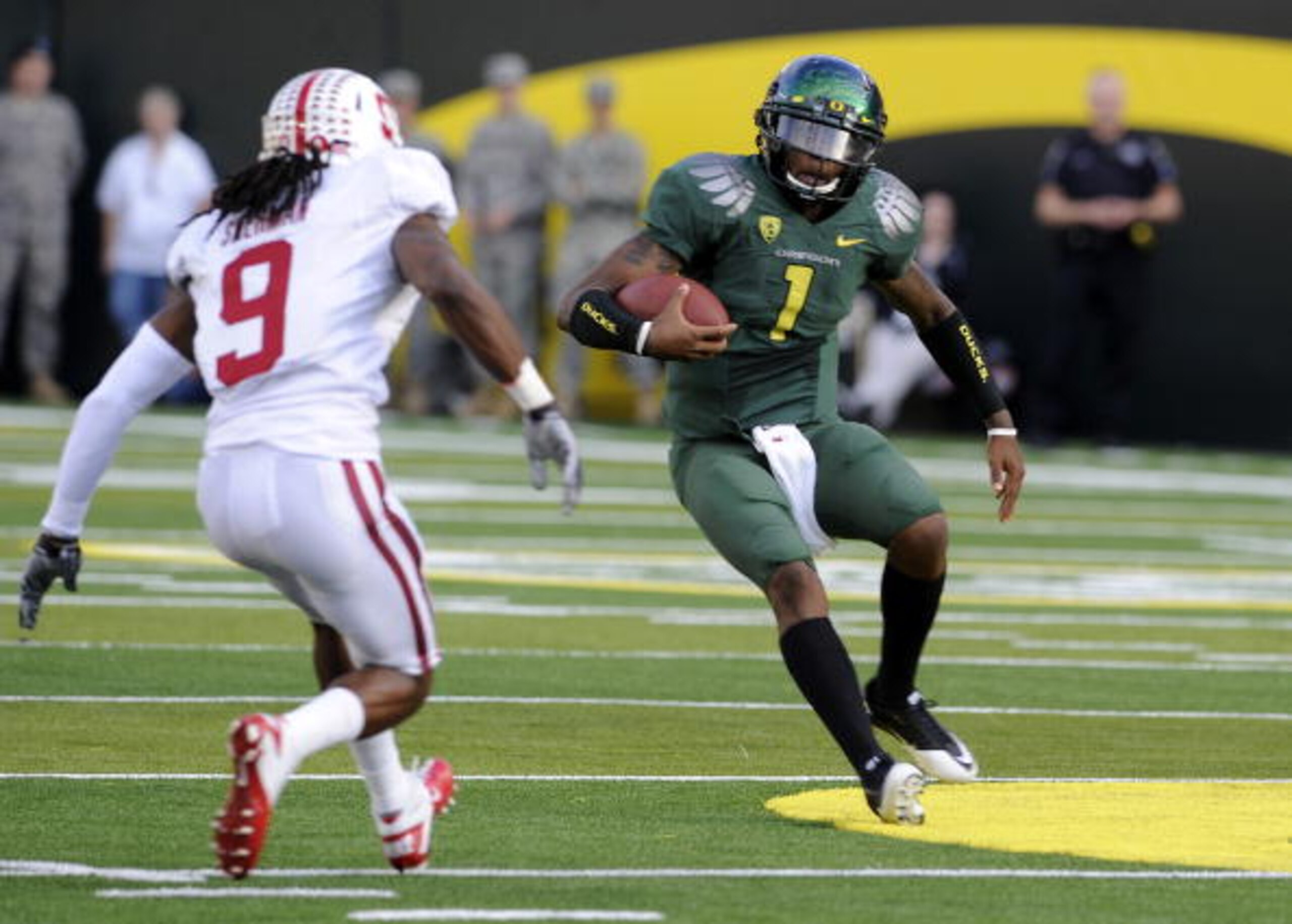 EUGENE, OR - OCTOBER 2: Quarterback Darron Thomas #1 of the Oregon Ducks makes a move on cornerback Richard Sherman #9 of Stanford as he runs with the ball in the first quarter of the game at Autzen Stadium on October 2, 2010 in Eugene, Oregon. (Photo by