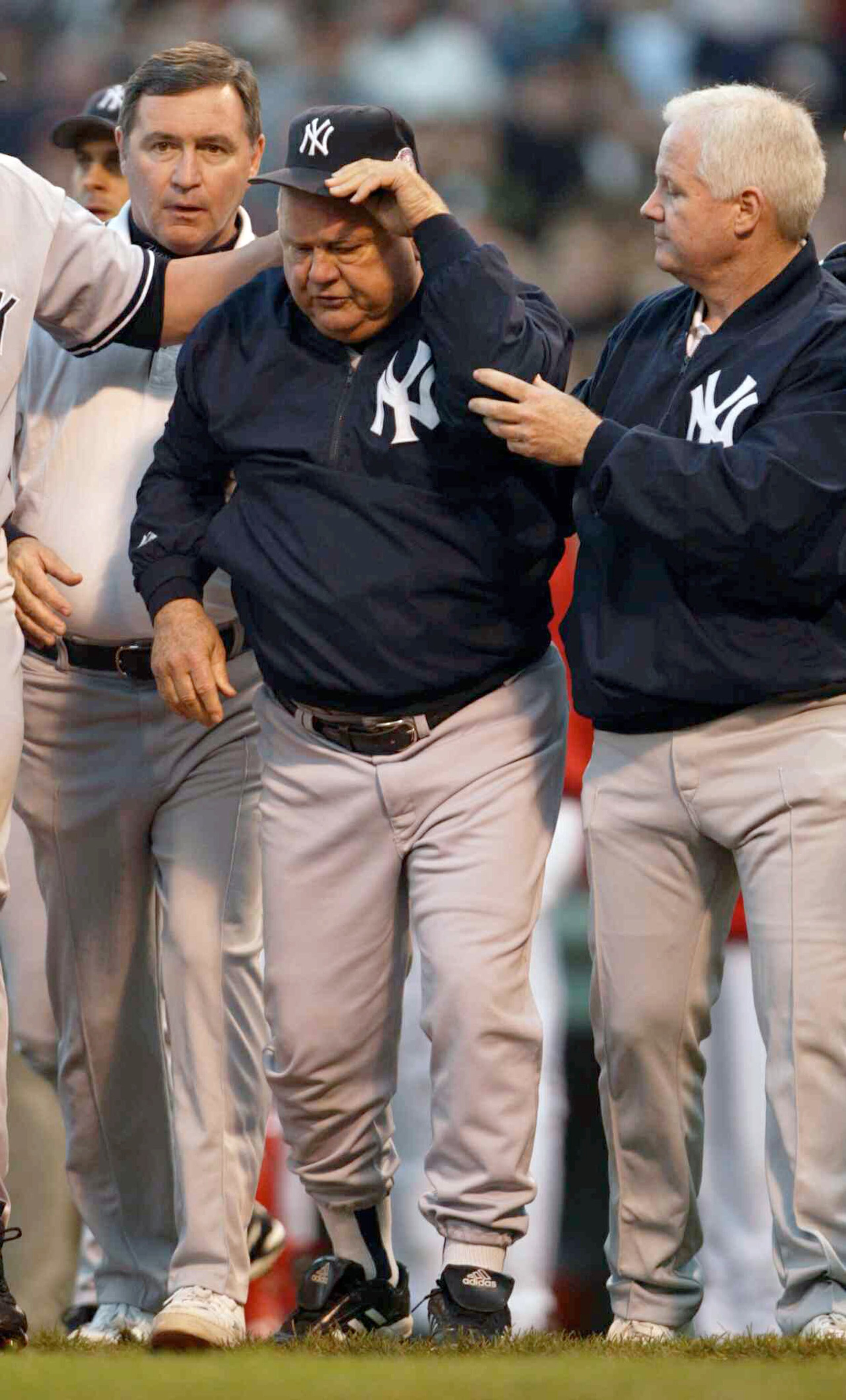 BOSTON - OCTOBER 11:  Bench coach Don Zimmer of the New York Yankees walks off the field after being thrown on the ground by Pedro Martinez #45 of the Boston Red Sox after he thought a pitch was thrown at him during Game 3 of the 2003 American League Cham