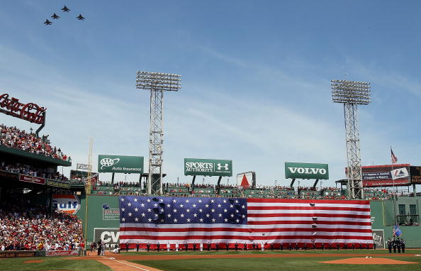 BOSTON - JULY 04:  Jets fly over as a giant flag covers the Green Monster before the game between the Baltimore Orioles and  the Boston Red Sox on July 4, 2010 at Fenway Park in Boston, Massachusetts.  (Photo by Elsa/Getty Images)