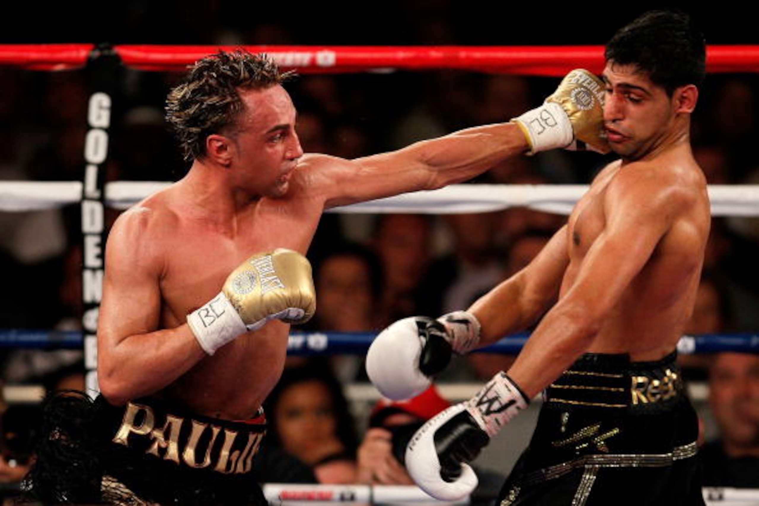 NEW YORK - MAY 15:   Paulie Malignaggi (L) hits Amir Khan of Great Britain during the WBA light welterweight title fight at Madison Square Garden on May 15, 2010 in New York City.  (Photo by Chris Trotman/Getty Images)