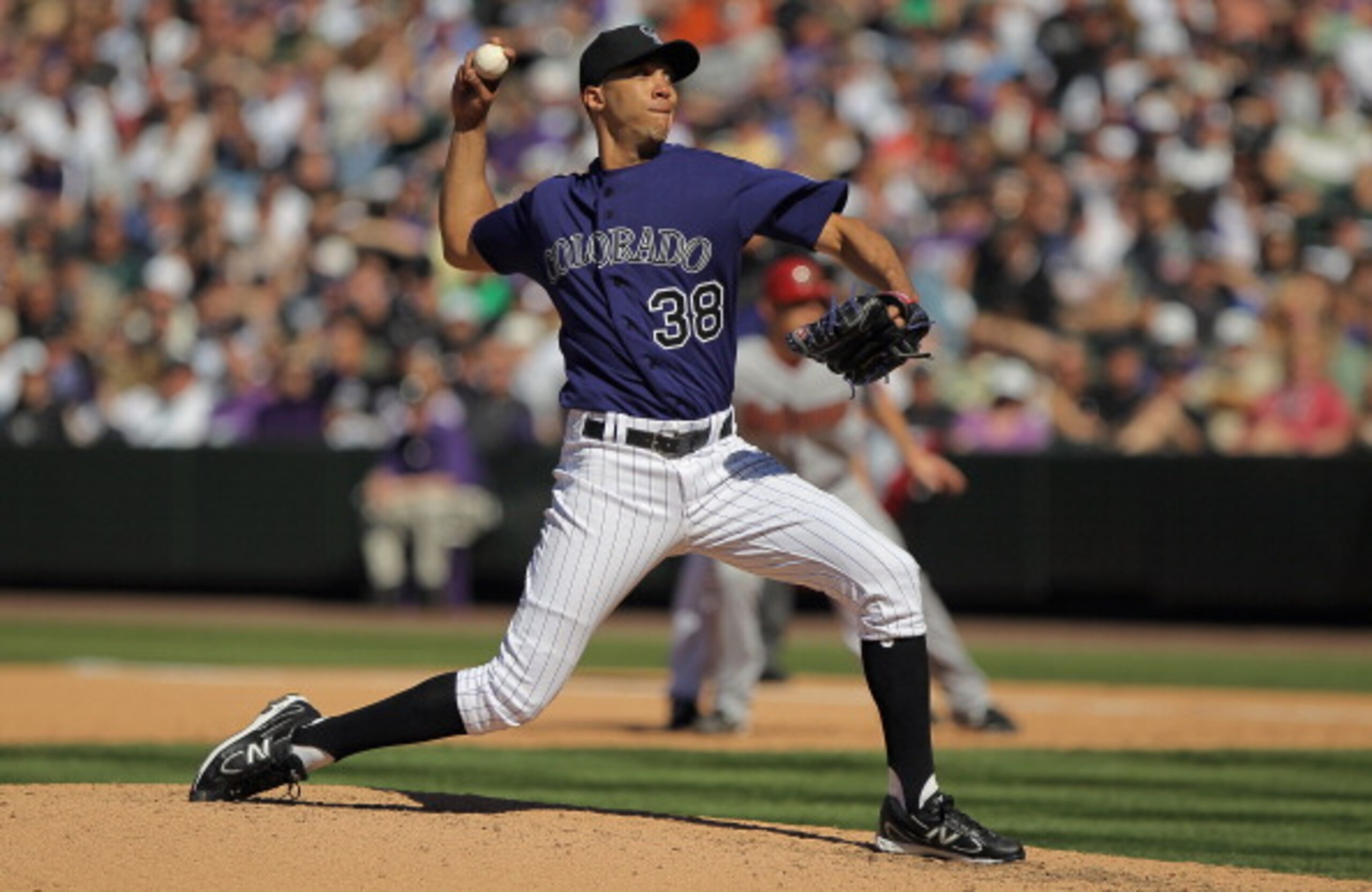 DENVER, CO - APRIL 01:  Starting pitcher Ubaldo Jimenez #38 of the Colorado Rockies delivers against the Arizona Diamondbacks during Opening Day at Coors Field on April 1, 2011 in Denver, Colorado.  (Photo by Doug Pensinger/Getty Images)