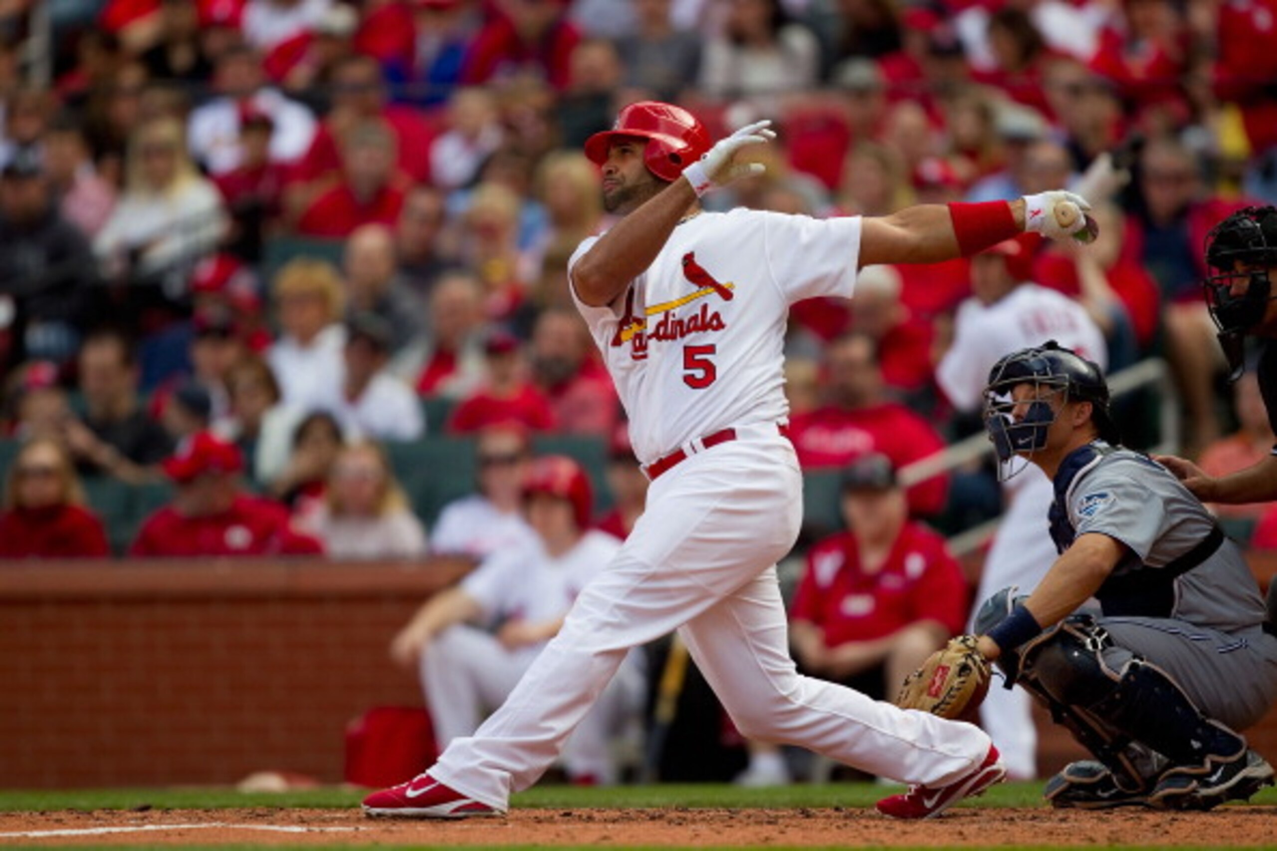 ST. LOUIS, MO - APRIL 2: Albert Pujols #5 of the St. Louis Cardinals hits a solo home run against the San Diego Padres at Busch Stadium on April 2, 2011 in St. Louis, Missouri.  (Photo by Dilip Vishwanat/Getty Images)