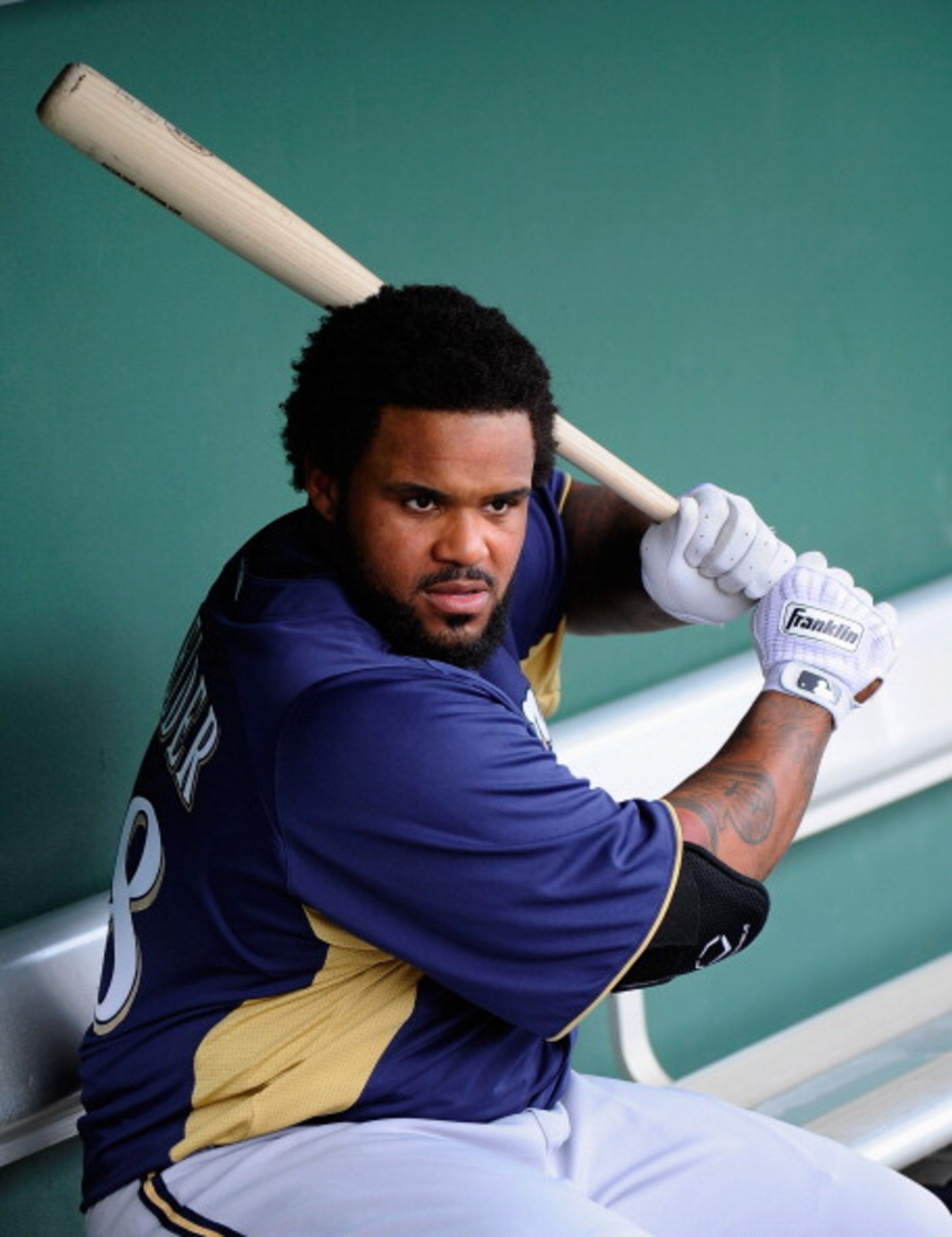 SCOTTSDALE, AZ - MARCH 14:  Prince Fielder#28 of the Milwaukee Brewers swings the bat in the dugout prior to the start of the spring training baseball game against the San Francisco Giants during the spring training baseball game at Scottsdale Stadium on