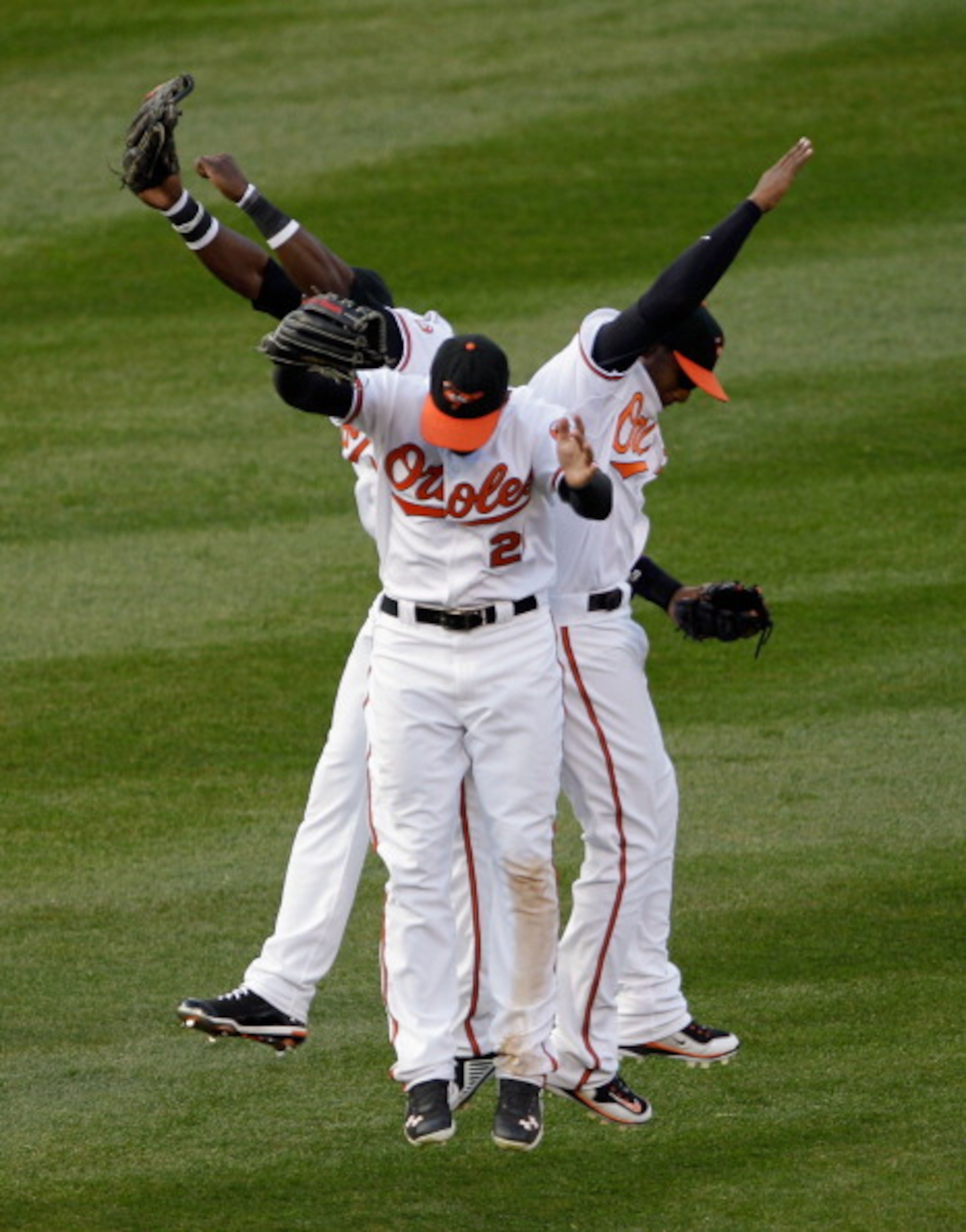 BALTIMORE, MD - APRIL 04: Felix Pie #18 of the Baltimore Orioles (L) and teammates Nick Markakis #21 (C) and Adam Jones #10 celebrate in the outfield after the Orioles defeated the Detroit Tigers 5-1 during opening day at Oriole Park at Camden Yards on A BALTIMORE, MD - APRIL 04: Felix Pie #18 of the Baltimore Orioles (L) and teammates Nick Markakis #21 (C) and Adam Jones #10 celebrate in the outfield after the Orioles defeated the Detroit Tigers 5-1 during opening day at Oriole Park at Camden Yards on A