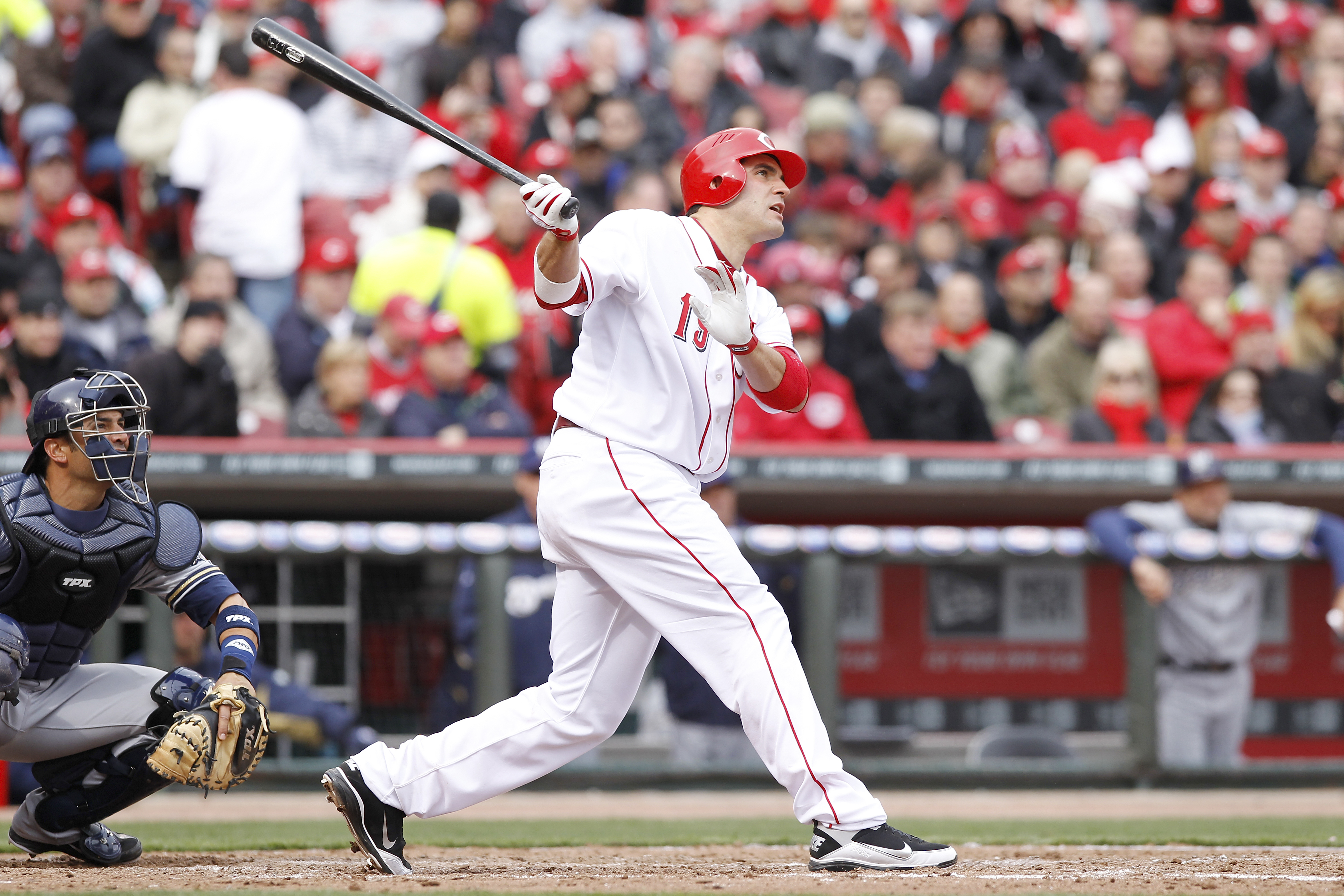 CINCINNATI, OH - MARCH 31: Joey Votto #19 of the Cincinnati Reds hits a home run in the seventh inning against the Milwaukee Brewers in the opening day game at Great American Ballpark on March 31, 2011 in Cincinnati, Ohio. The Reds won 7-6. (Photo by Joe 