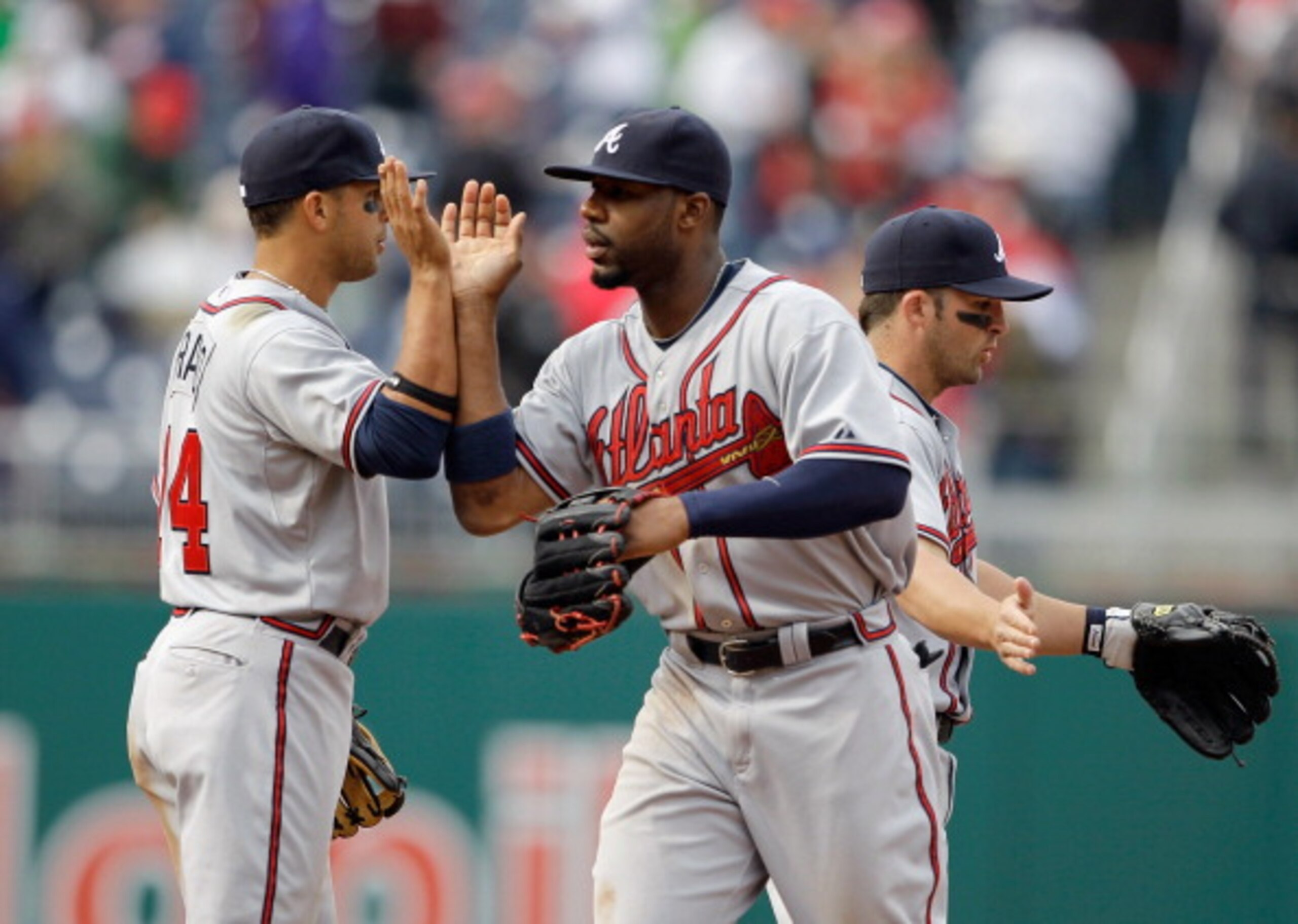WASHINGTON, DC - APRIL 03: Martin Prado #14 of the Atlanta Braves and teammate Jason Heyward #22 celebrate after they defeated the Washington Nationals 11-2 at Nationals Park on April 3, 2011 in Washington, DC.  (Photo by Rob Carr/Getty Images)