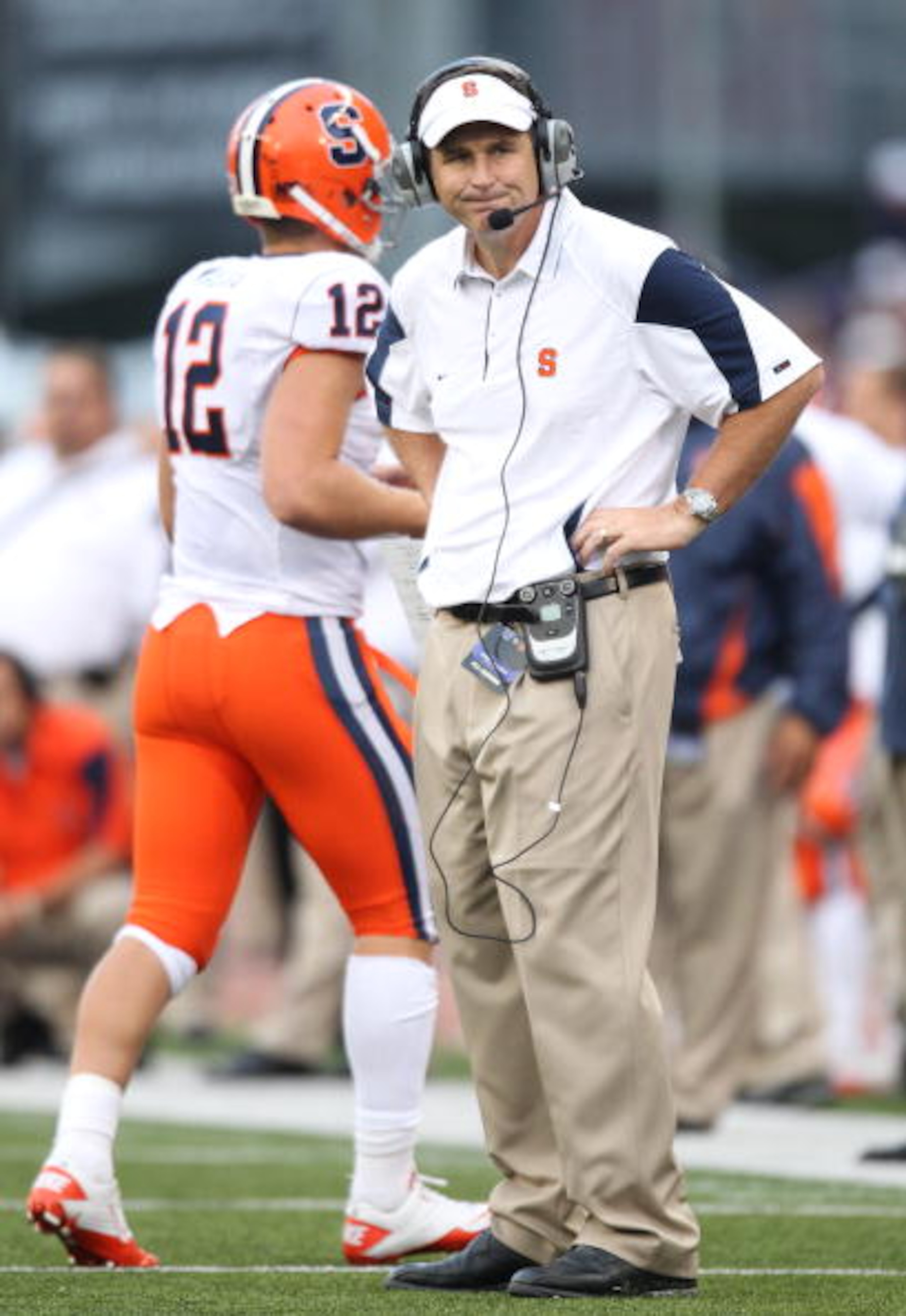 SEATTLE - SEPTEMBER 11:  Head coach Doug Marrone of the Syracuse Orange looks on as quarterback Ryan Nassib #12 comes off the field during the game against the Washington Huskies on September 11, 2010 at Husky Stadium in Seattle, Washington. (Photo by Ott