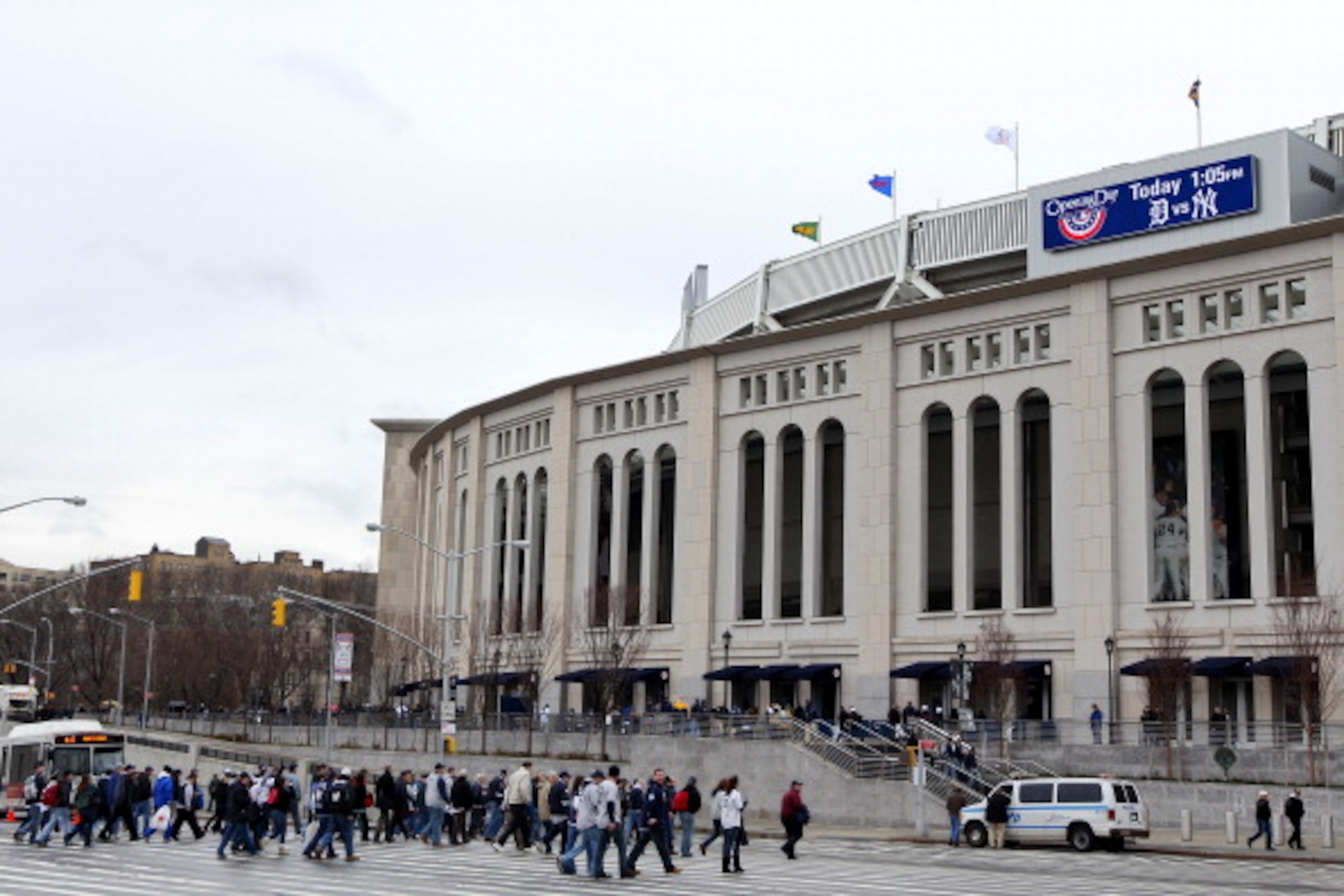 NEW YORK, NY - MARCH 31:  Fans cross the street outside of Yankee Stadium prior to the start of the game between the Detroit Tigers and the New York Yankees on Opening Day at Yankee Stadium on March 31, 2011 in the Bronx borough of New York City. (Photo b