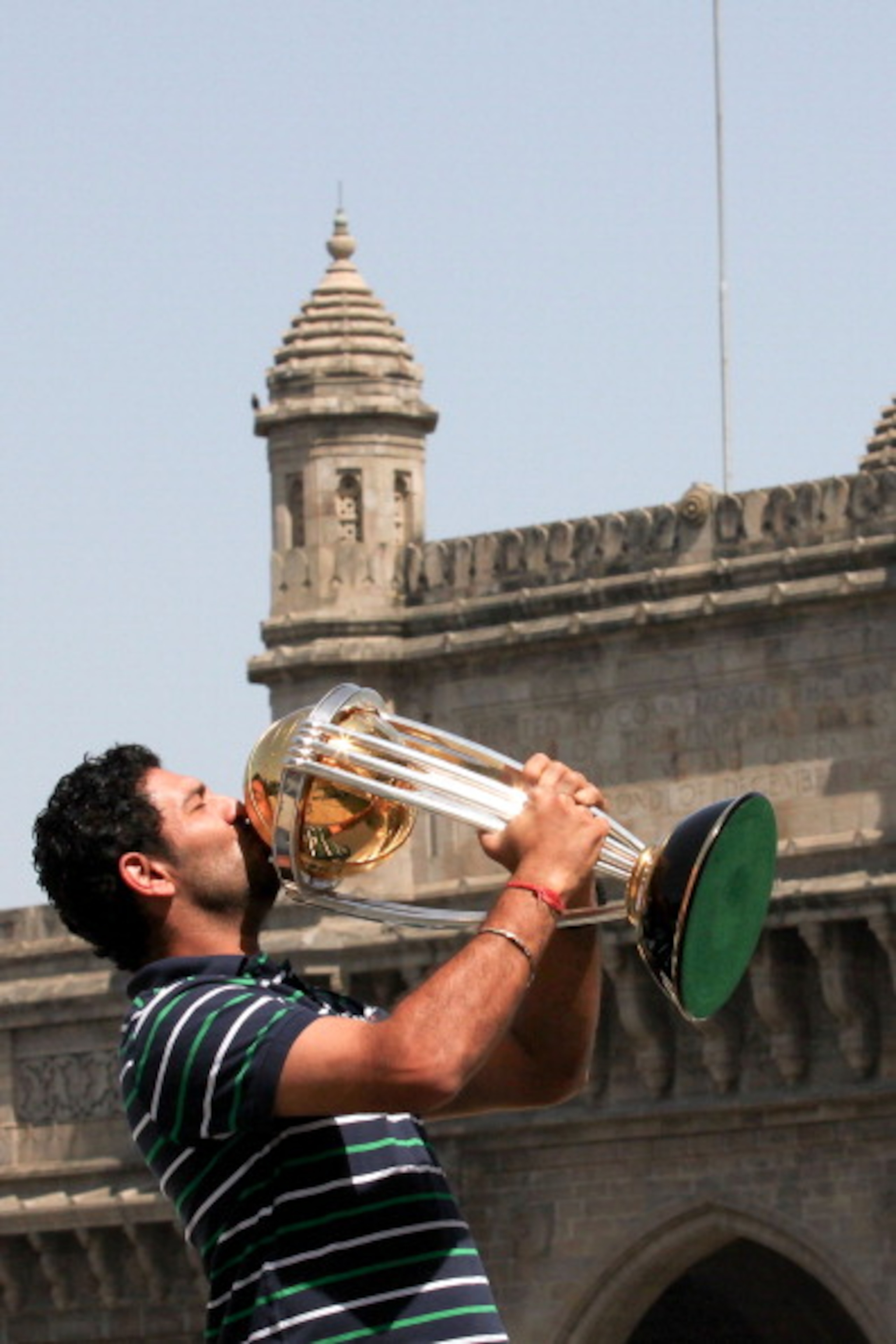 MUMBAI, INDIA - APRIL 03:  Yuvraj Singh of the Indian cricket team poses with the  ICC Cricket World Cup Trophy, with the Gateway of India in the backdrop, during a photo call at the Taj Palace Hotel on April 3, 2011 in Mumbai, India.  (Photo by Ritam Ban