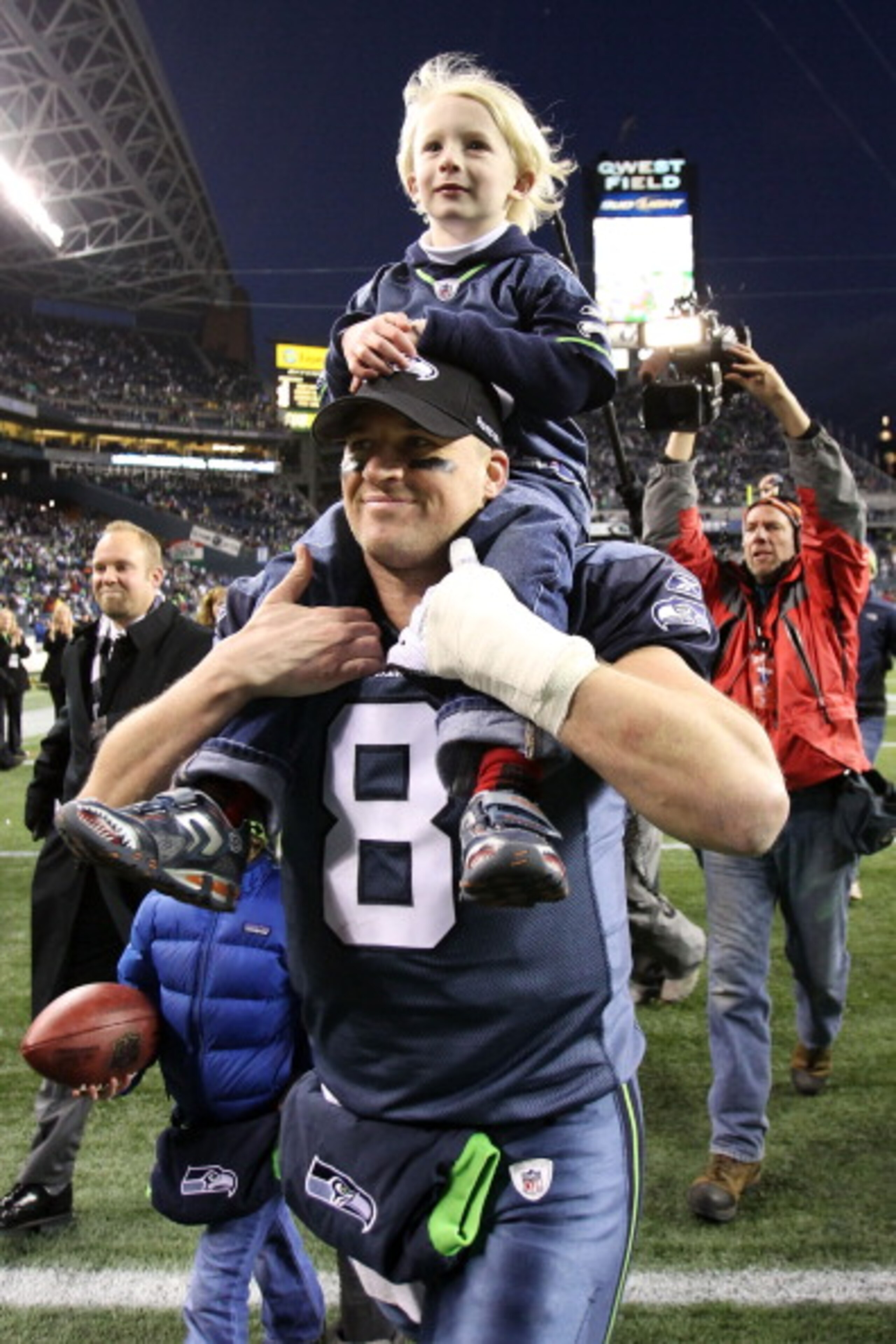 SEATTLE, WA - JANUARY 08: Quarterback Matt Hasselbeck #8 of the Seattle Seahawks celebrates the Seahawks 41-36 victory against the New Orleans Saints as his son Henry Hasselbeck is carried off on his back after the 2011 NFC wild-card playoff game at Qwest