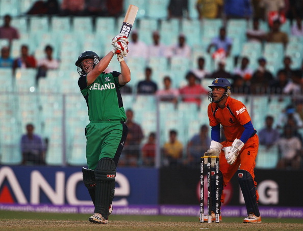 KOLKATA, INDIA - MARCH 18:  Kevin O'Brien of Ireland hits a six, as Atse Buurman of the Netherlands looks on during the 2011 ICC World Cup match between Ireland and Netherlands at Eden Gardens on March 18, 2011 in Kolkata, India.  (Photo by Matthew Lewis/