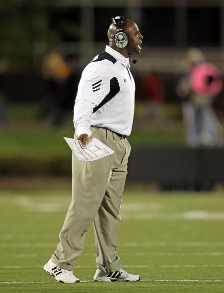 LOUISVILLE, KY - OCTOBER 15: Charlie Strong the Haed Coach of the Louisville Cardinals gives instructions to his team during the Big East Conference game against the Cincinnati Bearcats at Papa John's Cardinal Stadium on October 15, 2010 in Louisville, Ke
