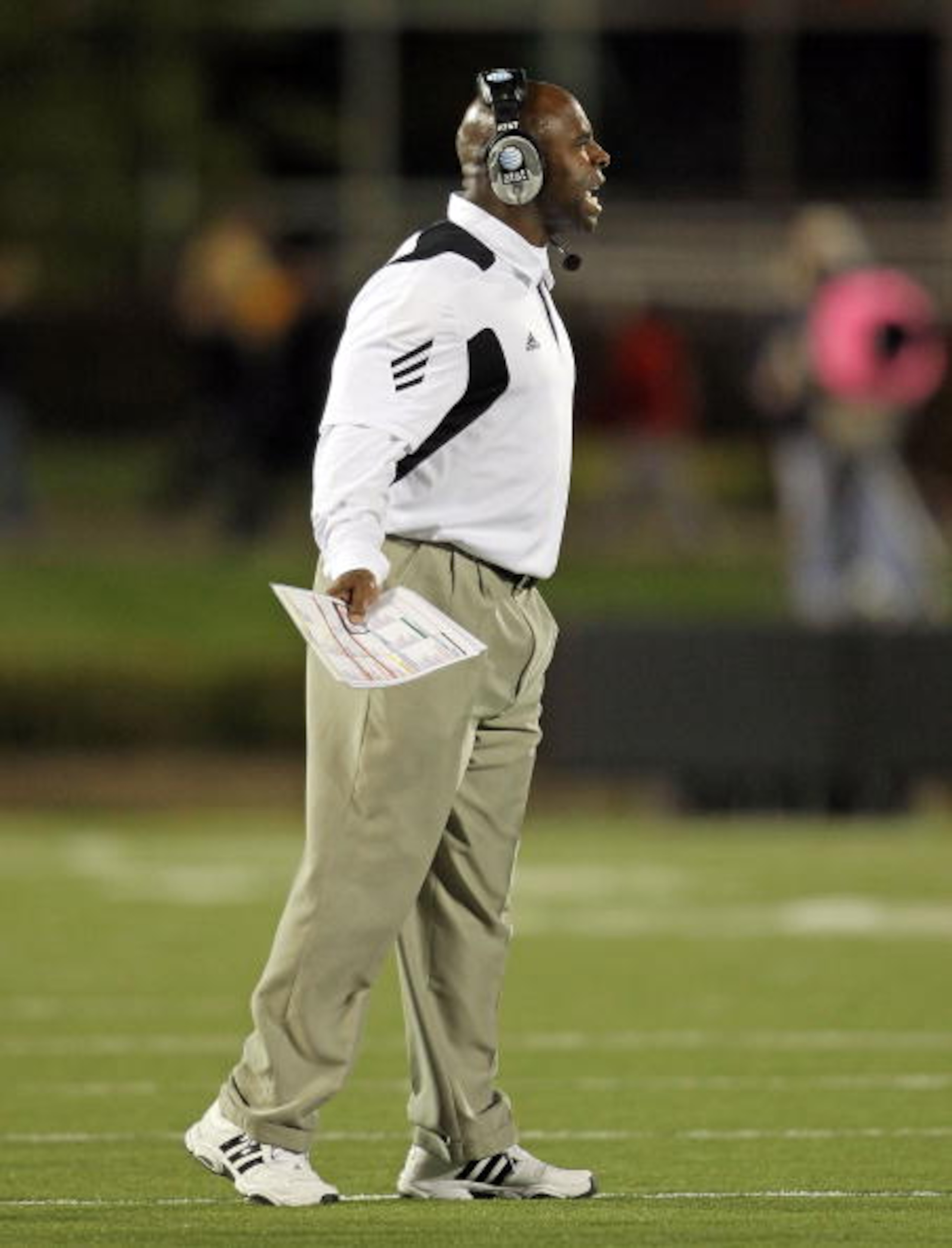 LOUISVILLE, KY - OCTOBER 15: Charlie Strong the Haed Coach of the Louisville Cardinals gives instructions to his team during the Big East Conference game against the Cincinnati Bearcats at Papa John's Cardinal Stadium on October 15, 2010 in Louisville, Ke