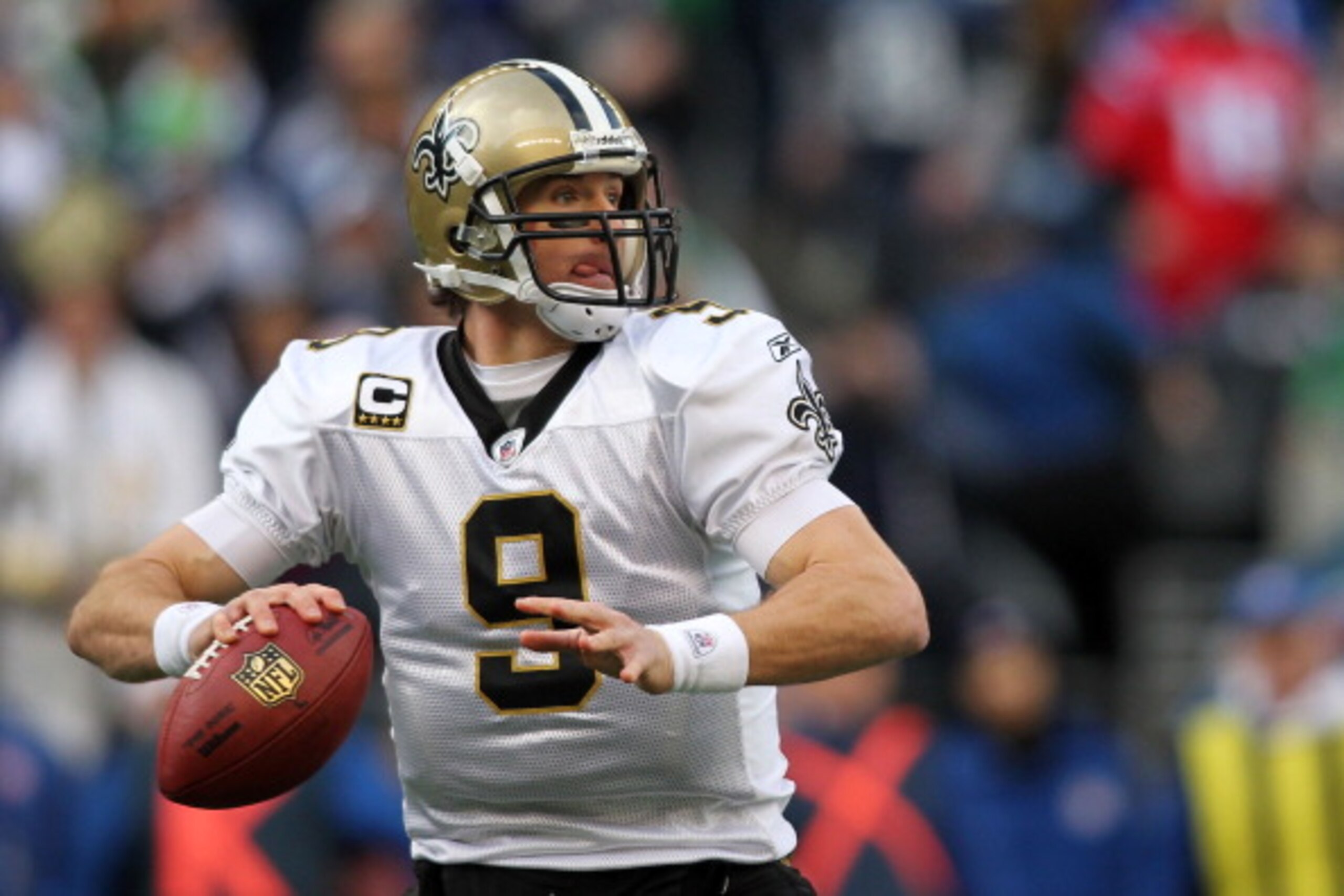 SEATTLE, WA - JANUARY 08:  Quarterback Drew Brees #9 of the New Orleans Saints scrambles against the Seattle Seahawks during the 2011 NFC wild-card playoff game at Qwest Field on January 8, 2011 in Seattle, Washington.  (Photo by Jonathan Ferrey/Getty Ima