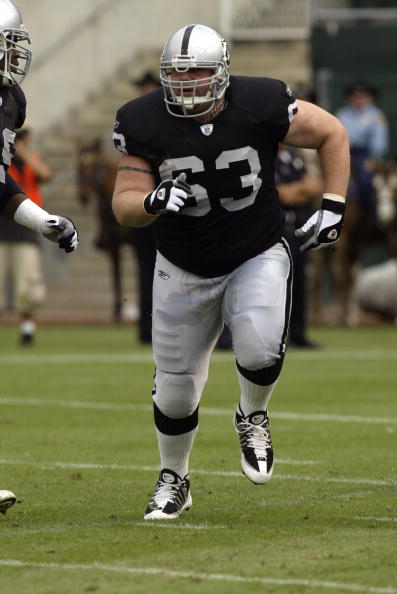 OAKLAND, CA  - SEPTEMBER 28:  Center Barrett Robbins #63 of the Oakland Raiders runs to block during a game against the San Diego Chargers on September 28, 2003 at Network Associates Coliseum in Oakland, California. The Raiders defeated the Chargers 34-31