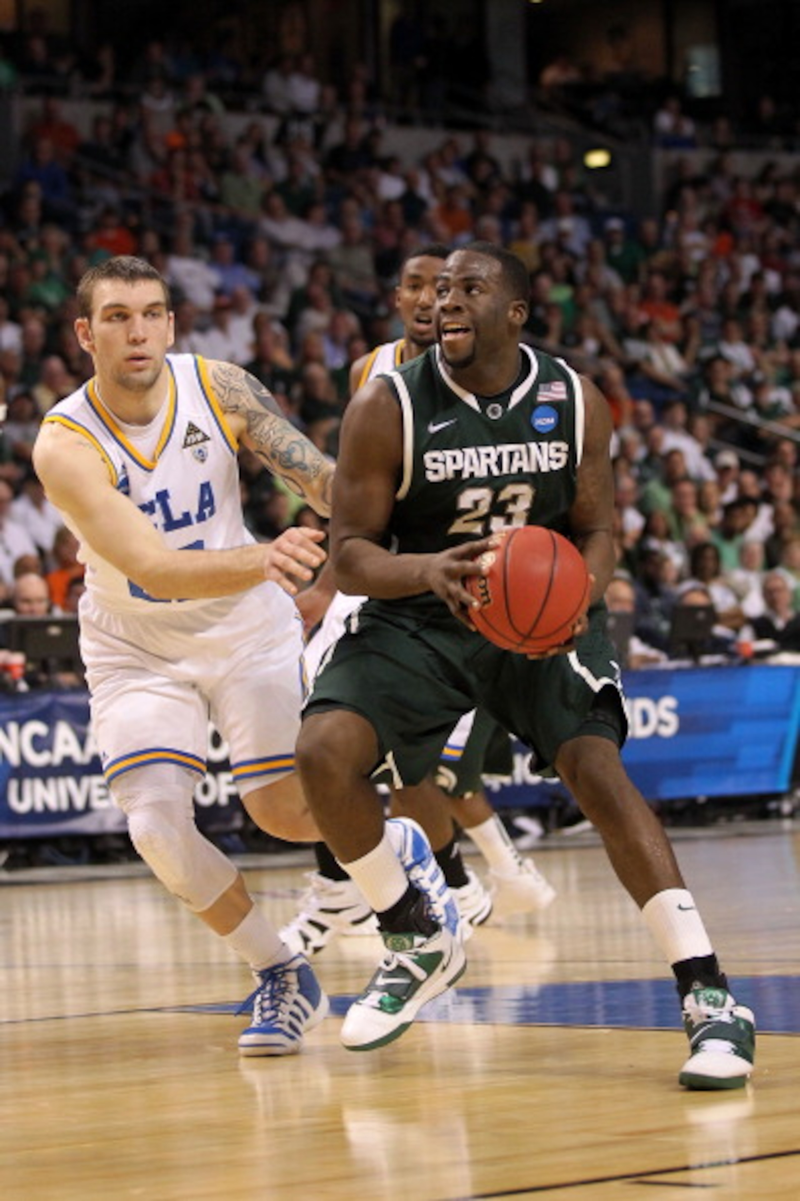 TAMPA, FL - MARCH 17:  Draymond Green #23 of the Michigan State Spartans drives against Reeves Nelson #22 of the UCLA Bruins in the first half during the second round of the 2011 NCAA men's basketball tournament at St. Pete Times Forum on March 17, 2011 i