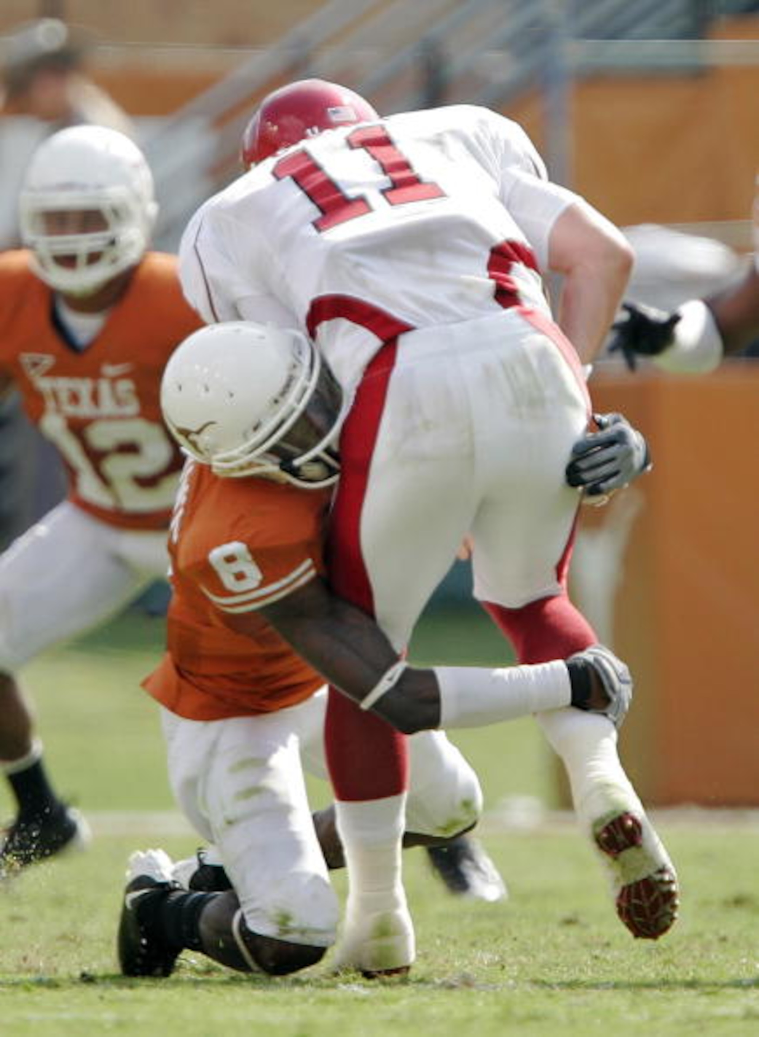 AUSTIN, TX - SEPTEMBER 27: Cornerback Chykie Brown #8 of the Texas Longhorns sacks quarterback Casey Dick #11 of the Arkansas Razorbacks for a loss of 8 yards in the second quarter on September 27, 2008 at Darrell K Royal-Texas Memorial Stadium in Austin AUSTIN, TX - SEPTEMBER 27: Cornerback Chykie Brown #8 of the Texas Longhorns sacks quarterback Casey Dick #11 of the Arkansas Razorbacks for a loss of 8 yards in the second quarter on September 27, 2008 at Darrell K Royal-Texas Memorial Stadium in Austin