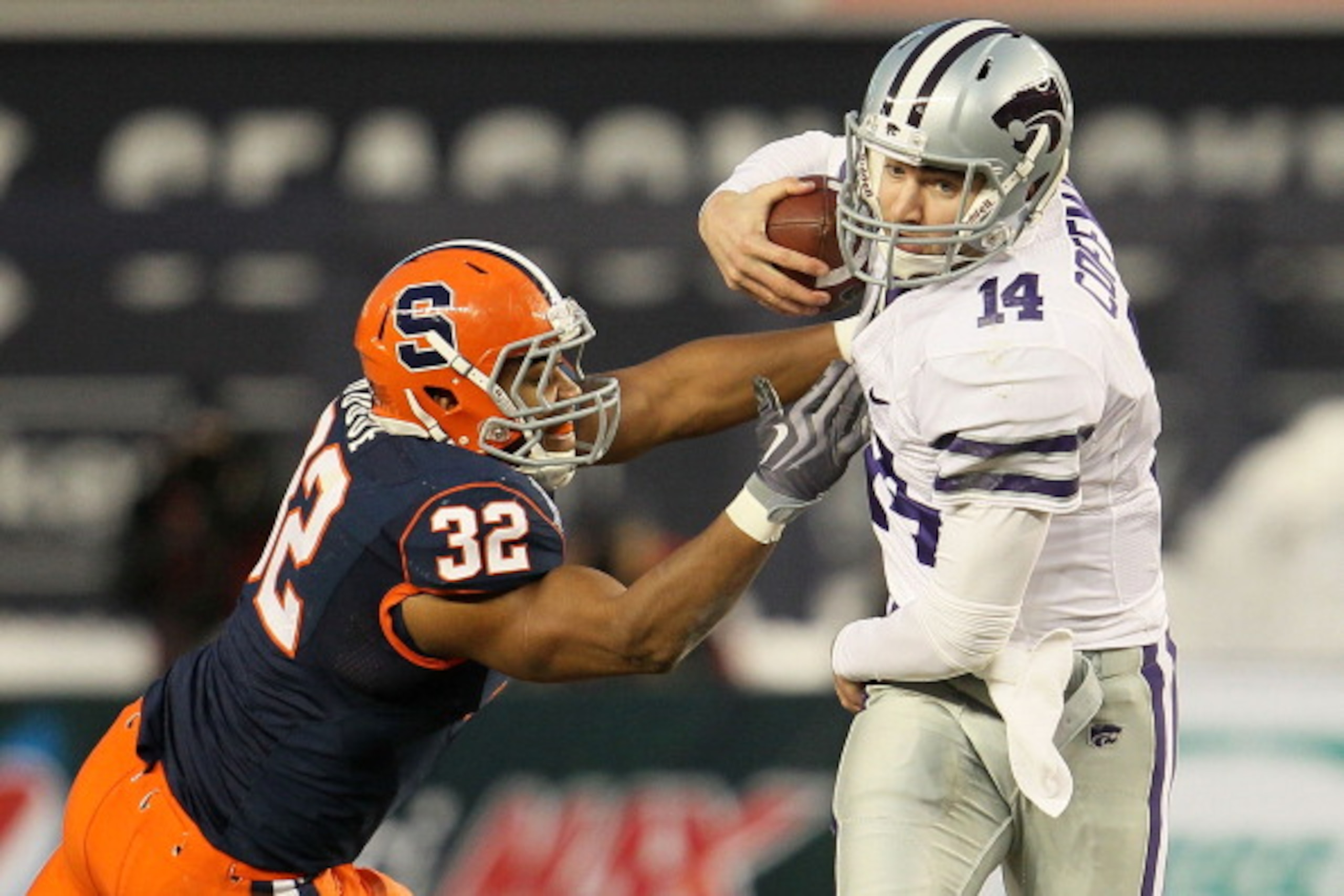 NEW YORK, NY - DECEMBER 30: Carson Coffman #14 of the Kansas State Wildcats gets out of the tackle of Doug Hogue #32 of the Syracuse Orange during the New Era Pinstripe Bowl at Yankee Stadium on December 30, 2010 in New York, New York. (Photo by Chris M NEW YORK, NY - DECEMBER 30: Carson Coffman #14 of the Kansas State Wildcats gets out of the tackle of Doug Hogue #32 of the Syracuse Orange during the New Era Pinstripe Bowl at Yankee Stadium on December 30, 2010 in New York, New York. (Photo by Chris M