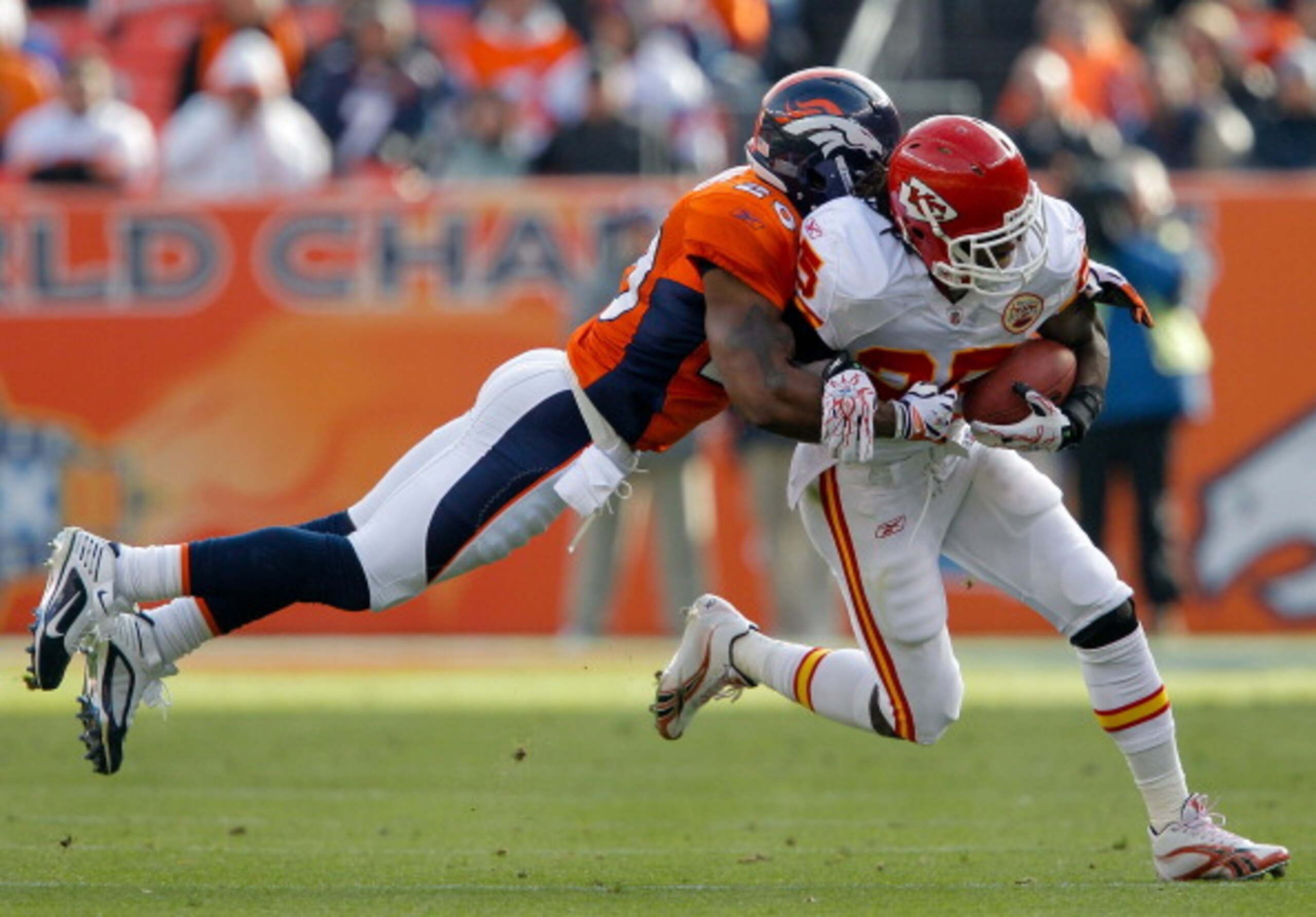 DENVER - NOVEMBER 14:  Safety Brian Dawkins #20 of the Denver Broncos makes a diving attempt to tackle running back Jamaal Charles #25 of the Kansas City Chiefs during the first quarter at INVESCO Field at Mile High on November 14, 2010 in Denver, Colorad