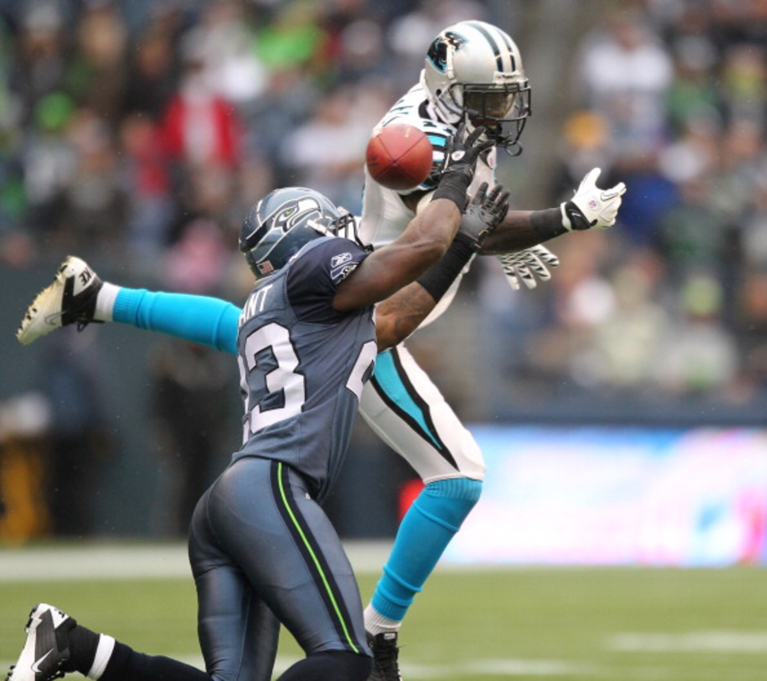 SEATTLE - DECEMBER 05:  Wide receiver Brandon LaFell #11 of the Carolina Panthers just misses this pass against Marcus Trufant #23 of the Seattle Seahawks at Qwest Field on December 5, 2010 in Seattle, Washington. The Seahawks won, 31-14. (Photo by Otto G