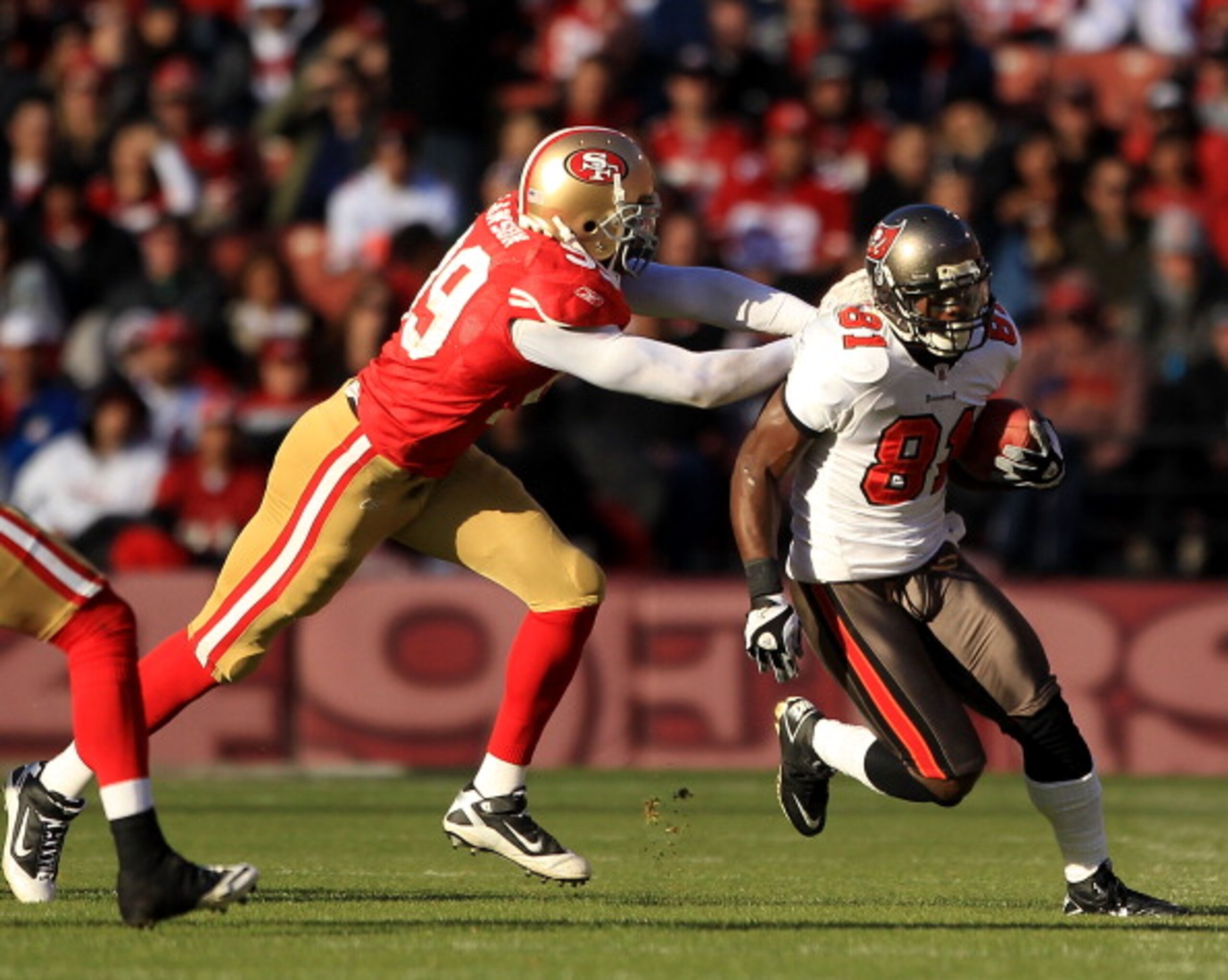 SAN FRANCISCO - NOVEMBER 21:  Micheal Spurlock #81 of the Tampa Bay Buccaneers tries turnover outrun Manny Lawson #99 of the San Francisco 49ers at Candlestick Park on November 21, 2010 in San Francisco, California.  (Photo by Ezra Shaw/Getty Images)