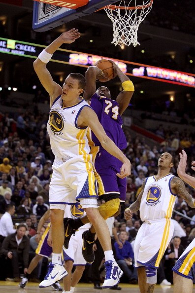OAKLAND, CA - JANUARY 12: Kobe Bryant #24 of the Los Angeles Lakers is fouled by Andris Biedrins #15 of the Golden State Warriors at Oracle Arena on January 12, 2011 in Oakland, California. NOTE TO USER: User expressly acknowledges and agrees that, by dow