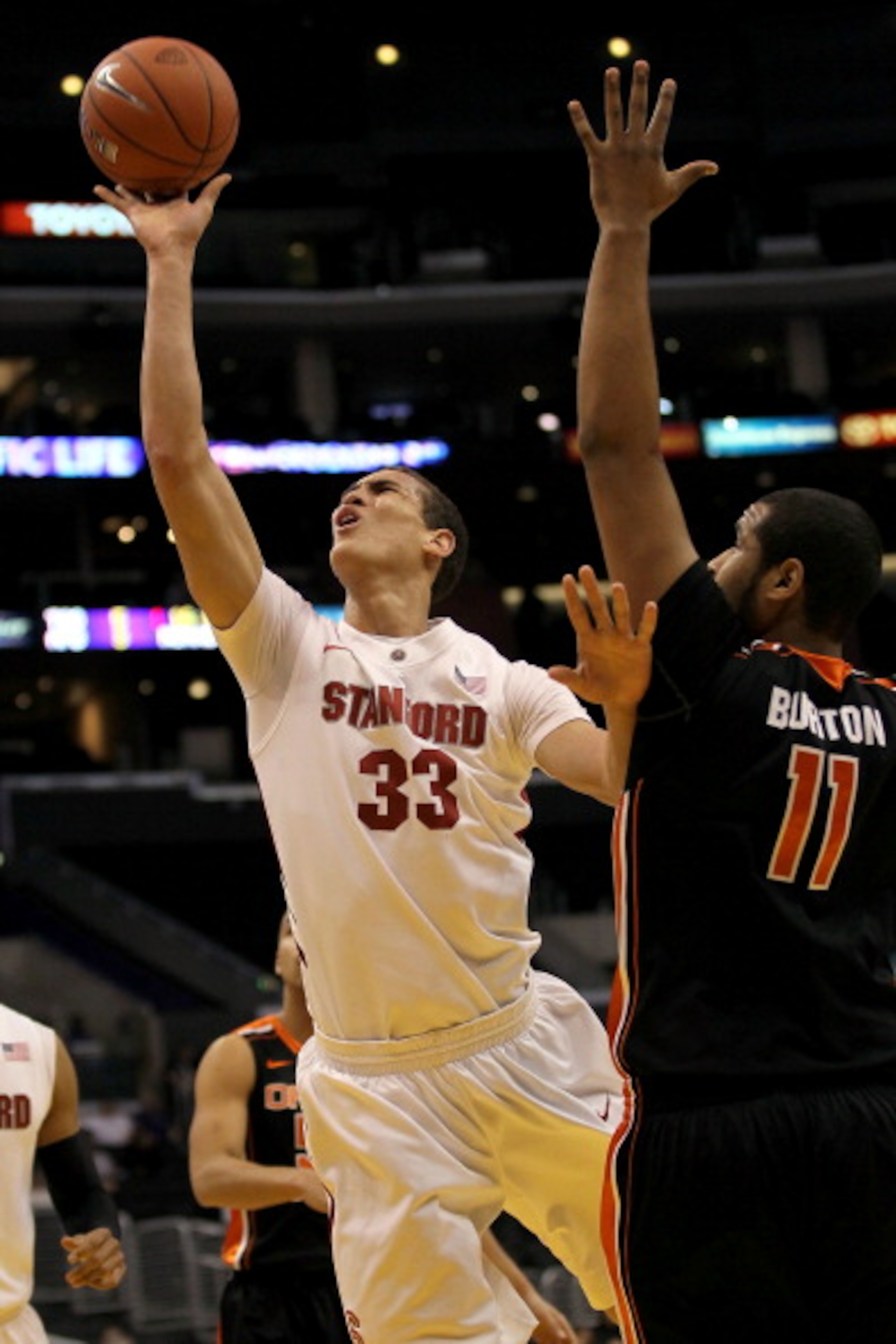 LOS ANGELES, CA - MARCH 09:  Dwight Powell #33 of the Stanford Cardinal goes up for a shot over Joe Burton #11 of the Oregon State Beavers in the first half of the first round of the 2011 Pacific Life Pac-10 Men's Basketball Tournament at Staples Center o