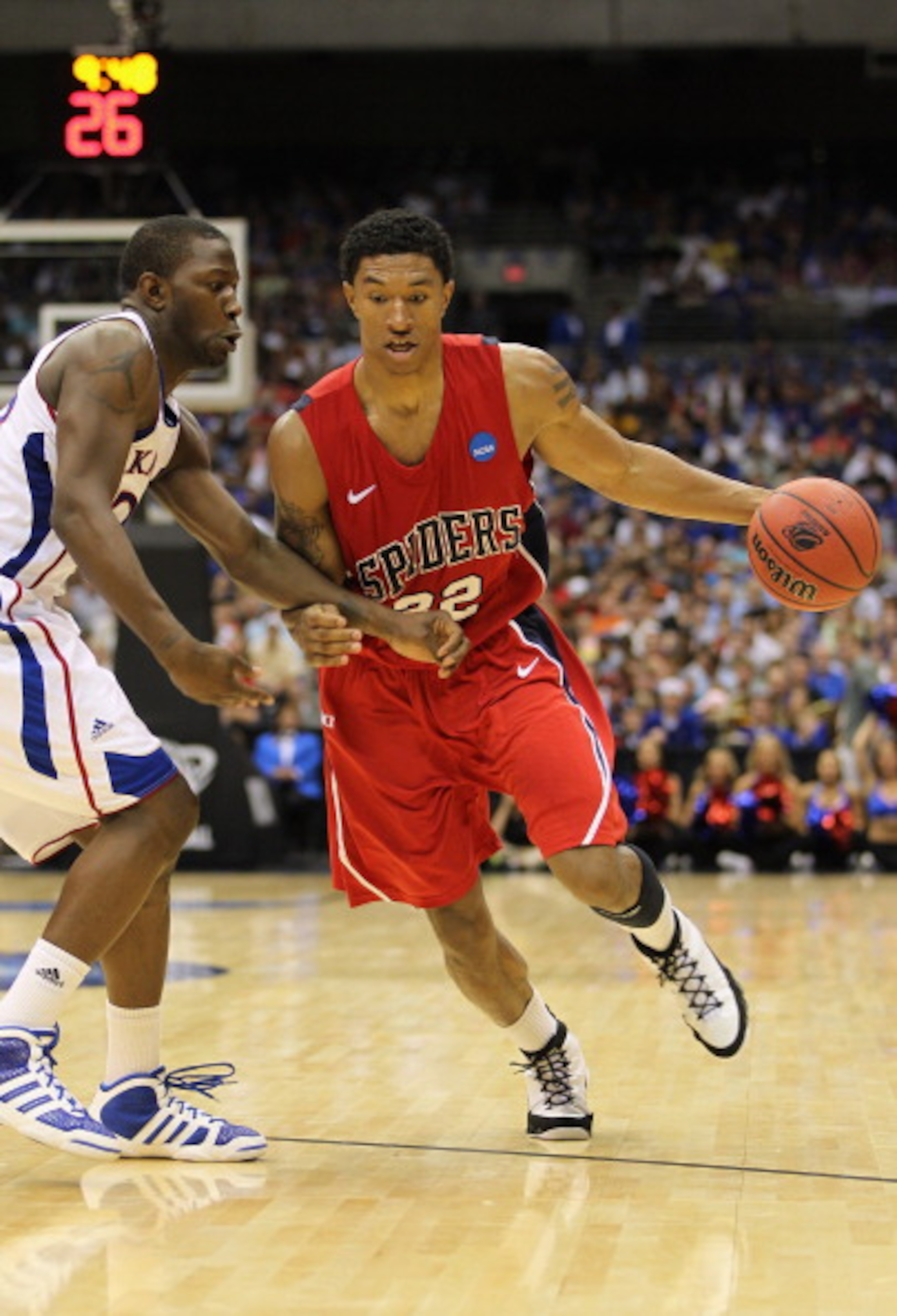 SAN ANTONIO, TX - MARCH 25: Justin Harper #32 of the Richmond Spiders drives against the Kansas Jayhawks during the southwest regional of the 2011 NCAA men's basketball tournament at the Alamodome on March 25, 2011 in San Antonio, Texas. Kansas defeated SAN ANTONIO, TX - MARCH 25: Justin Harper #32 of the Richmond Spiders drives against the Kansas Jayhawks during the southwest regional of the 2011 NCAA men's basketball tournament at the Alamodome on March 25, 2011 in San Antonio, Texas. Kansas defeated