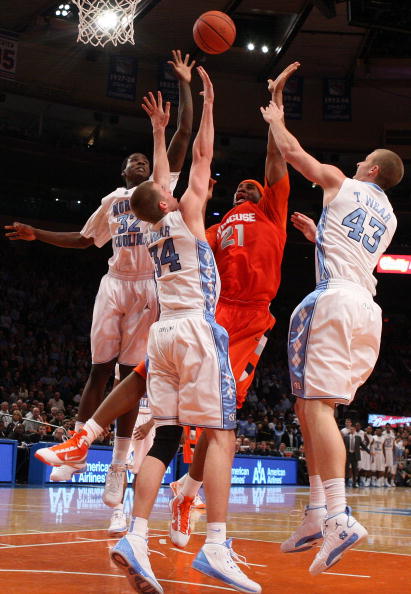 NEW YORK - NOVEMBER 20:  Arinze Onuaku #21 of the Syracuse Orange shoots against Ed Davis #32, David Wear #34, and Travis Wear #43 of the North Carolina Tar Heels during the championship game of the 2K Sports Classic on November 20, 2009 at Madison Square