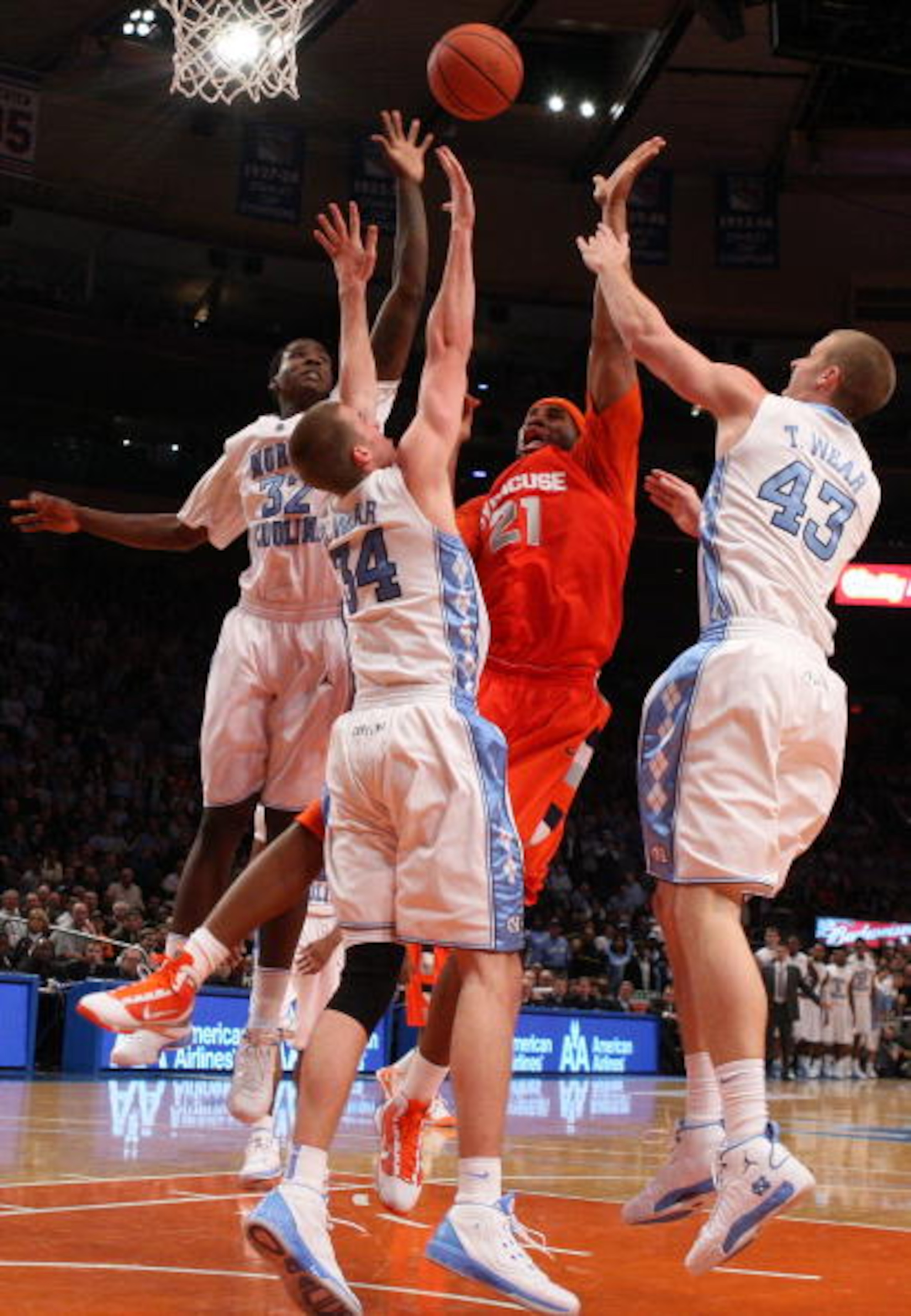 NEW YORK - NOVEMBER 20:  Arinze Onuaku #21 of the Syracuse Orange shoots against Ed Davis #32, David Wear #34, and Travis Wear #43 of the North Carolina Tar Heels during the championship game of the 2K Sports Classic on November 20, 2009 at Madison Square