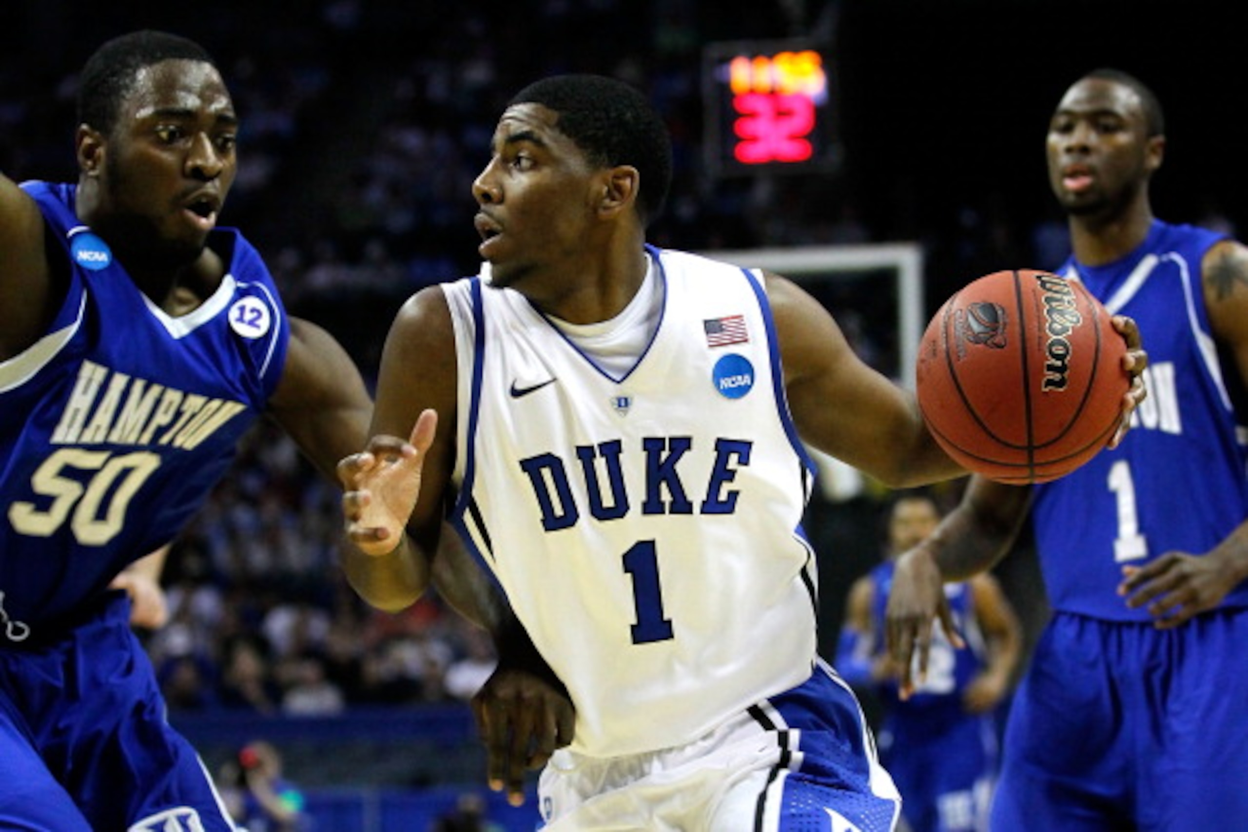 CHARLOTTE, NC - MARCH 18:  Kyrie Irving #1 of the Duke Blue Devils drives on Milade Lola-Charles #50 of the Hampton Pirates in the first half during the second round of the 2011 NCAA men's basketball tournament at Time Warner Cable Arena on March 18, 2011