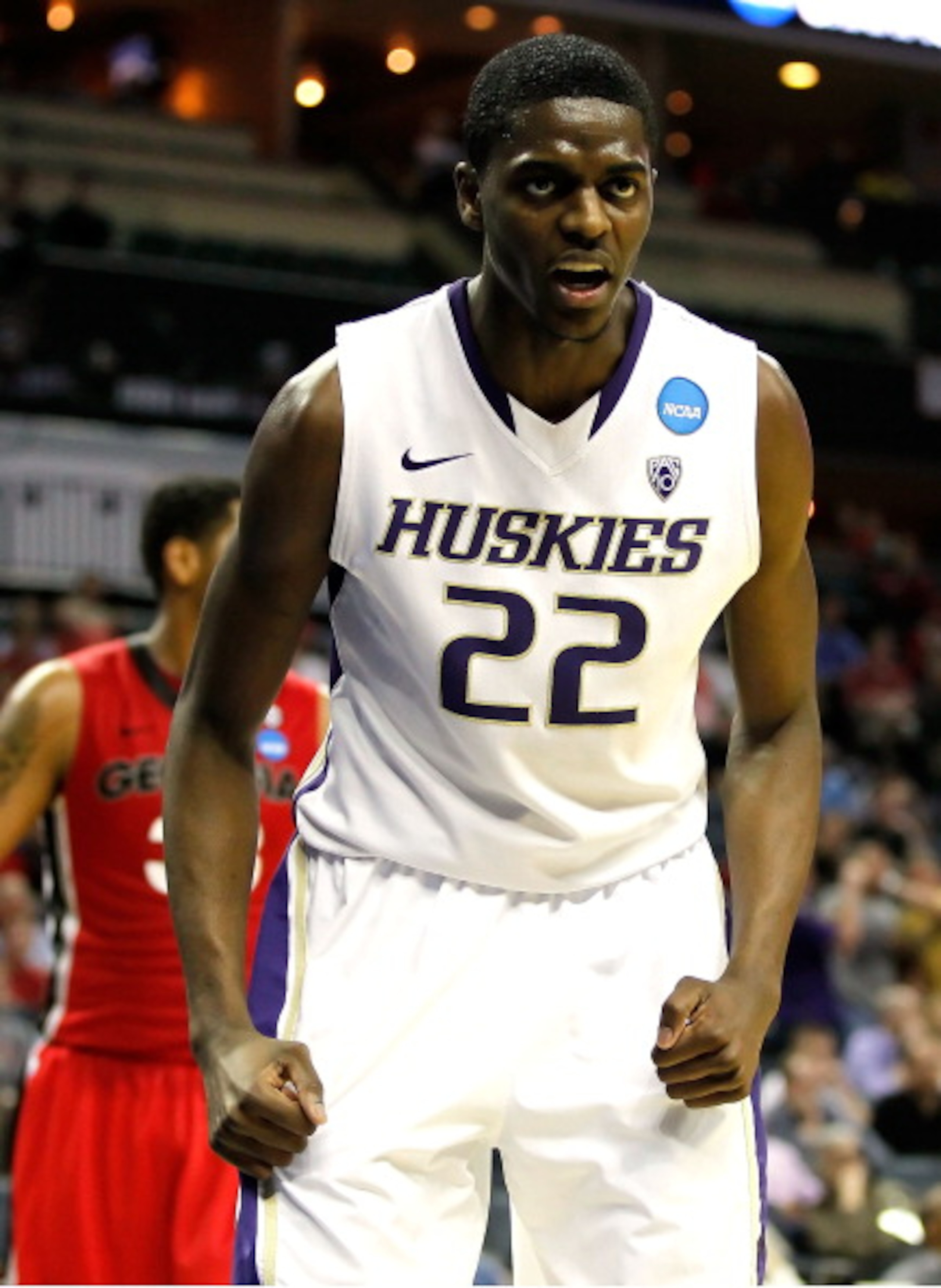 CHARLOTTE, NC - MARCH 18:  Justin Holiday #22 of the Washington Huskies reacts in the second half while taking on the Georgia Bulldogs during the second round of the 2011 NCAA men's basketball tournament at Time Warner Cable Arena on March 18, 2011 in Cha