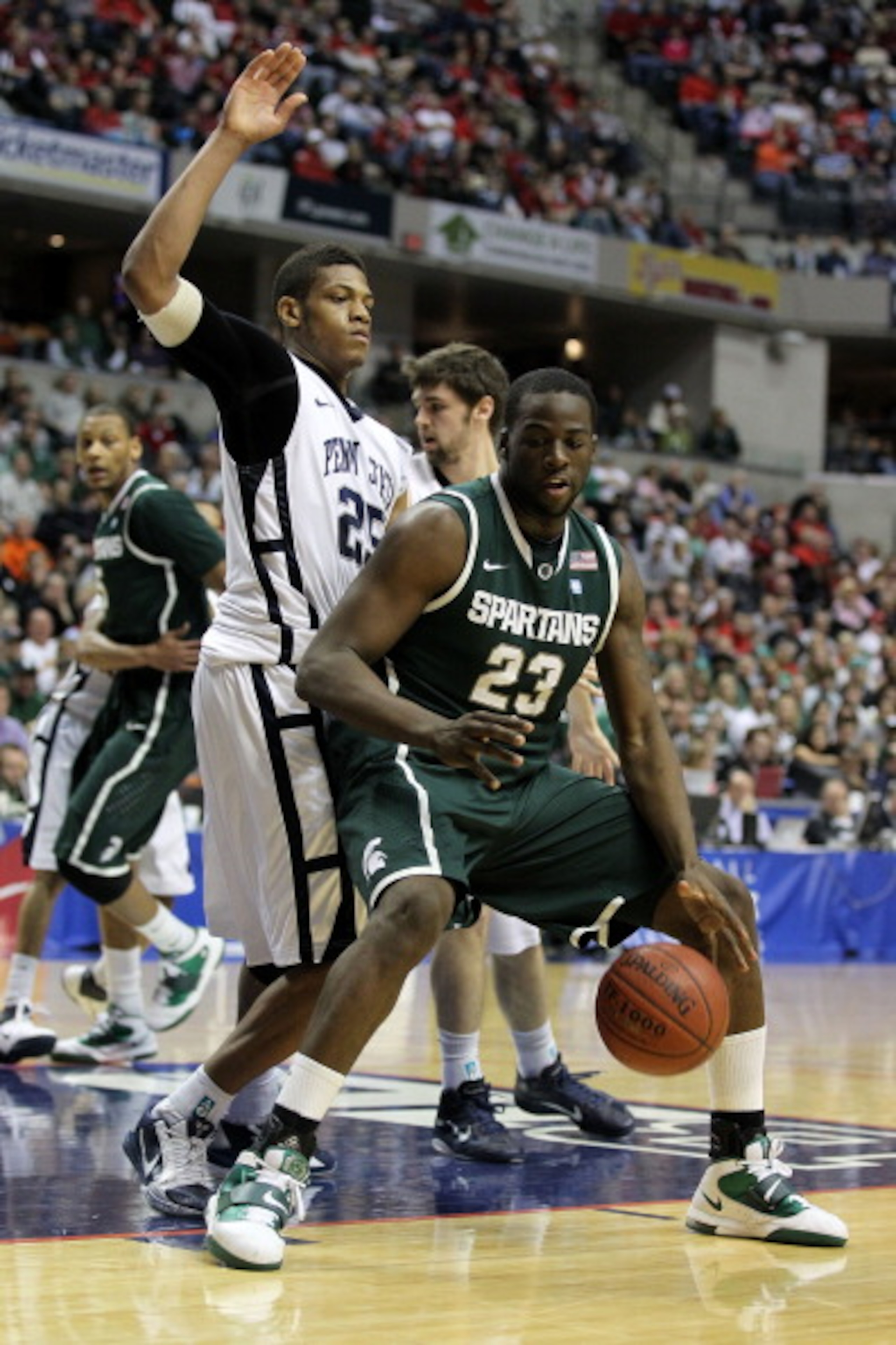 INDIANAPOLIS, IN - MARCH 12:  Draymond Green #23 of the Michigan State Spartans posts up against Jeff Brooks #25 of the Penn State Nittany Lions during the semifinals of the 2011 Big Ten Men's Basketball Tournament at Conseco Fieldhouse on March 12, 2011