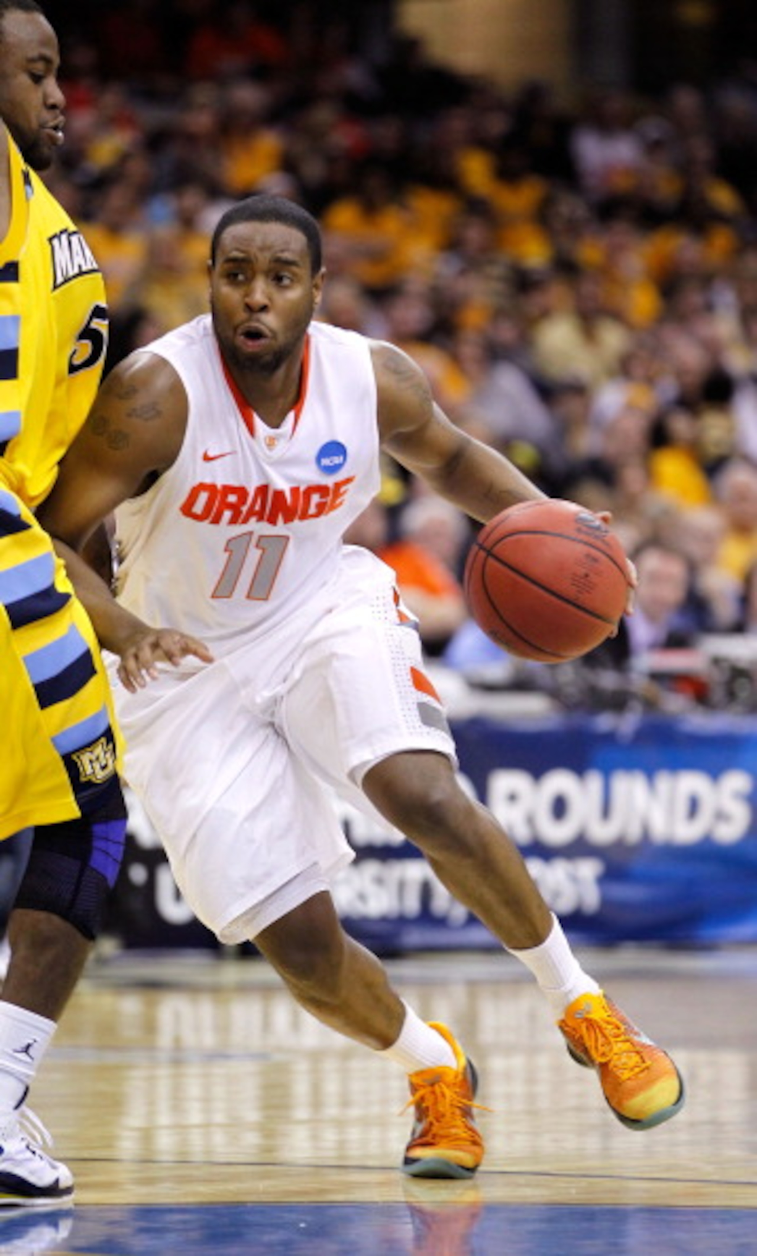 CLEVELAND, OH - MARCH 20: Scoop Jardine #11 of the Syracuse Orange handles the ball against Junior Cadougan #5 of the Marquette Golden Eagles during the third of the 2011 NCAA men's basketball tournament at Quicken Loans Arena on March 20, 2011 in Clevela