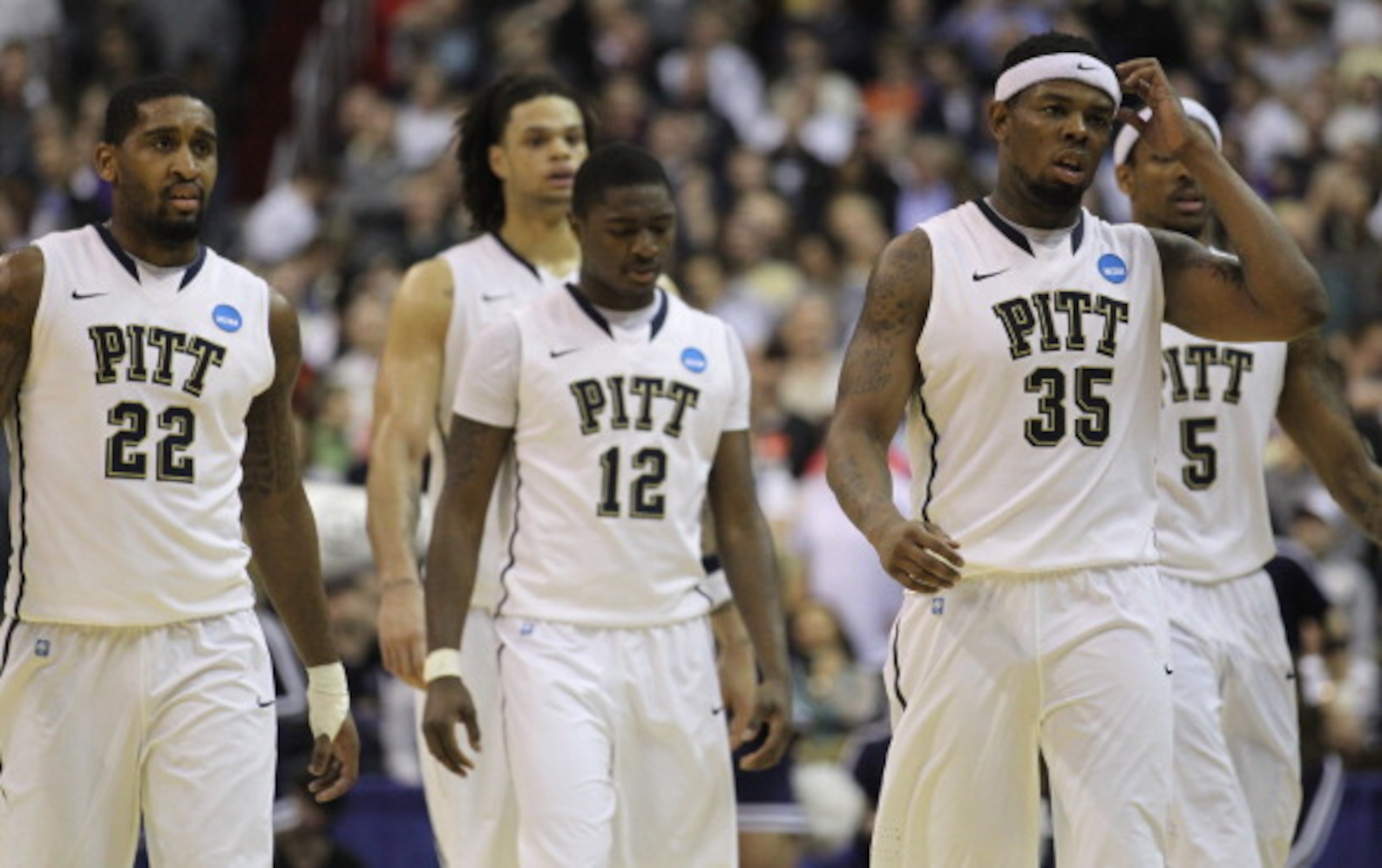 WASHINGTON - MARCH 19:  Members of the Pittsburgh basketball team including Nasir Robinson #35, Ashton Gibbs #12; and Brad Wanamaker#22 walk off the court following their loss against Butler in the third round of the 2011 NCAA men's basketball tournament