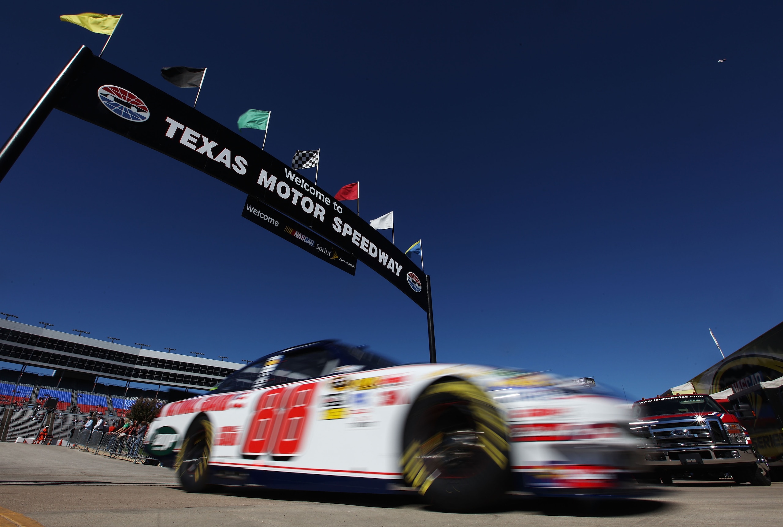 FORT WORTH, TX - NOVEMBER 05:  Dale Earnhardt Jr. drives the #88 National Guard/AMP Energy Chevrolet through the garage area during practice for the NASCAR Sprint Cup Series AAA Texas 500 at Texas Motor Speedway on November 5, 2010 in Fort Worth, Texas.