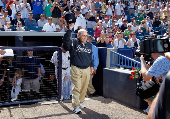 TAMPA, FL - FEBRUARY 26:  Hall of Famer Yogi Berra of the New York Yankees tips his hat to the crowd as he is announced just prior to the start of the Grapefruit League Spring Training Game against the Philadelphia Phillies at George M. Steinbrenner Field